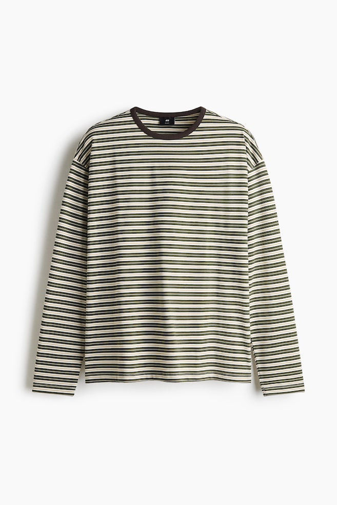 A front-facing long-sleeve T-shirt features horizontal stripes in olive green, cream, and brown. The shirt has a relaxed fit with dropped shoulders, long sleeves, and a contrasting dark brown ribbed crew neck. - 1