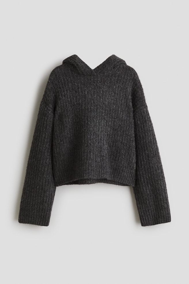 A dark gray, loose-fit hoodie in a soft rib knit is presented FRONT, featuring a hood with a wrapover front, dropped shoulders, and long sleeves. - 1