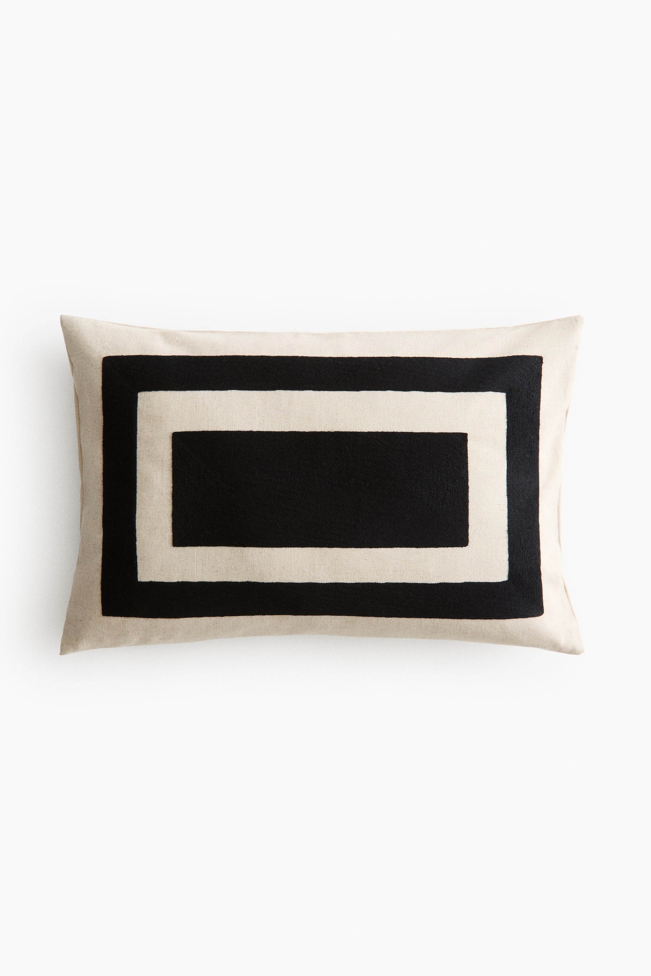 View larger image: A rectangular cushion cover crafted from a linen and cotton blend with a rustic weave showcases an embroidered graphic pattern of two concentric black rectangles on its light-coloured front. A zipper runs along one side.