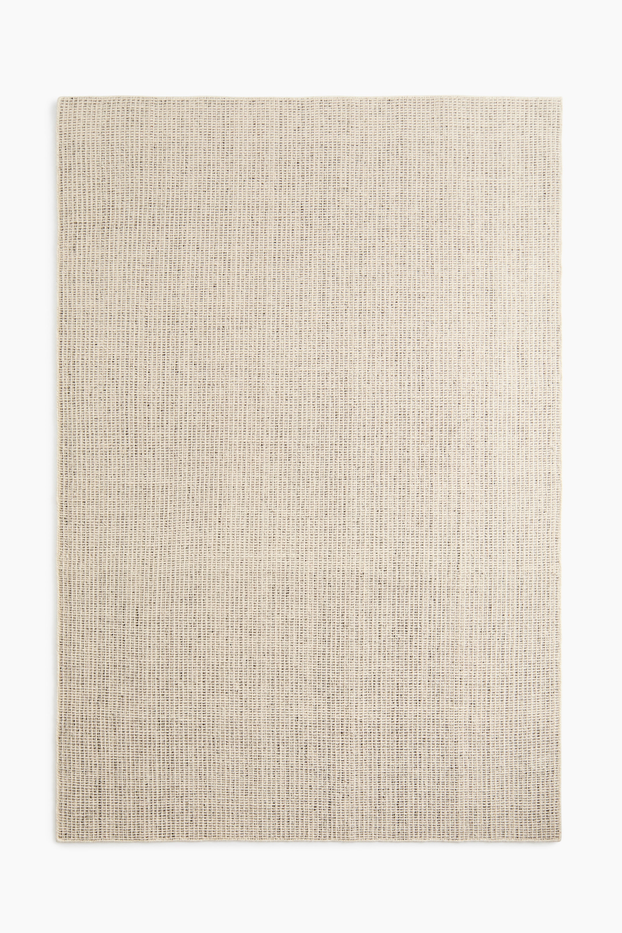 View larger image: A handwoven wool rug showcasing a finely textured weave and subtle colour variations of light beige interspersed with darker flecks, laid flat and viewed from above.