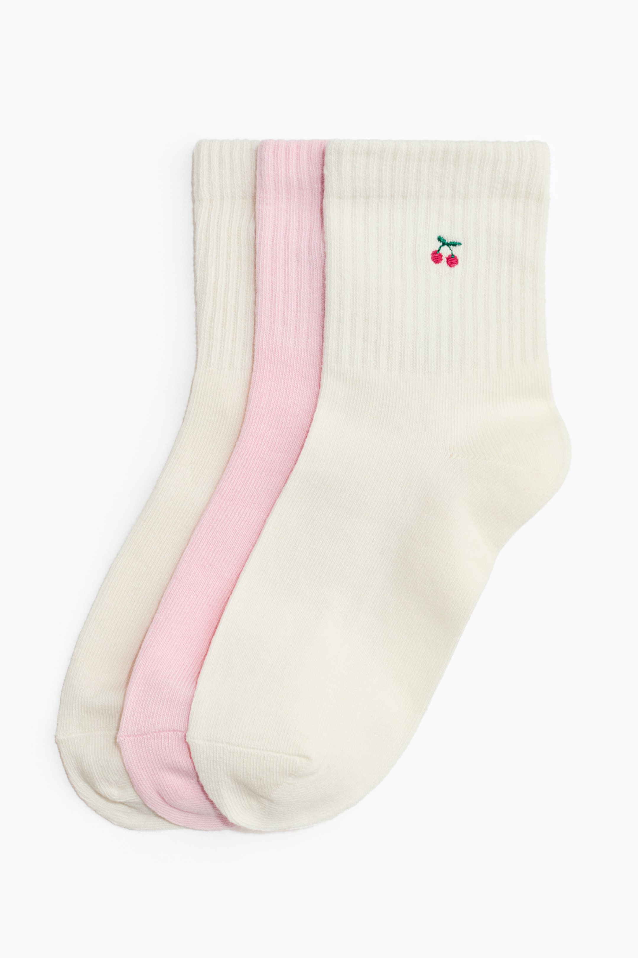 View larger image: Three socks are facing FRONT, stacked together. Two cream-colored socks and one light pink sock are visible, with the top cream sock featuring a small embroidered cherry motif above its ribbed cuff.