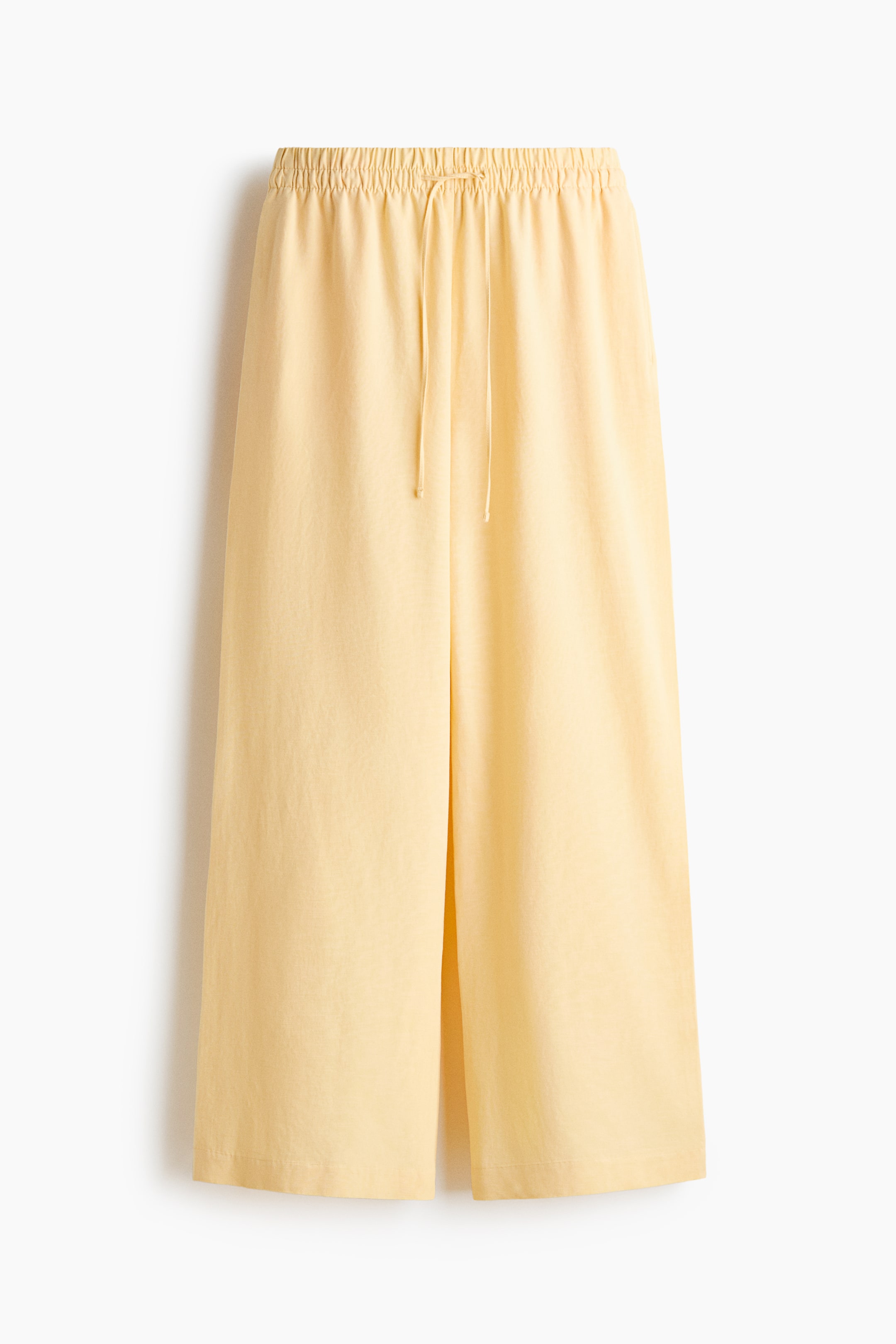 View larger image: Loose-fit trousers crafted from a breezy linen and viscose blend are showcased from the front, highlighting an elasticated drawstring waist, subtle side pockets, and wide-leg design.