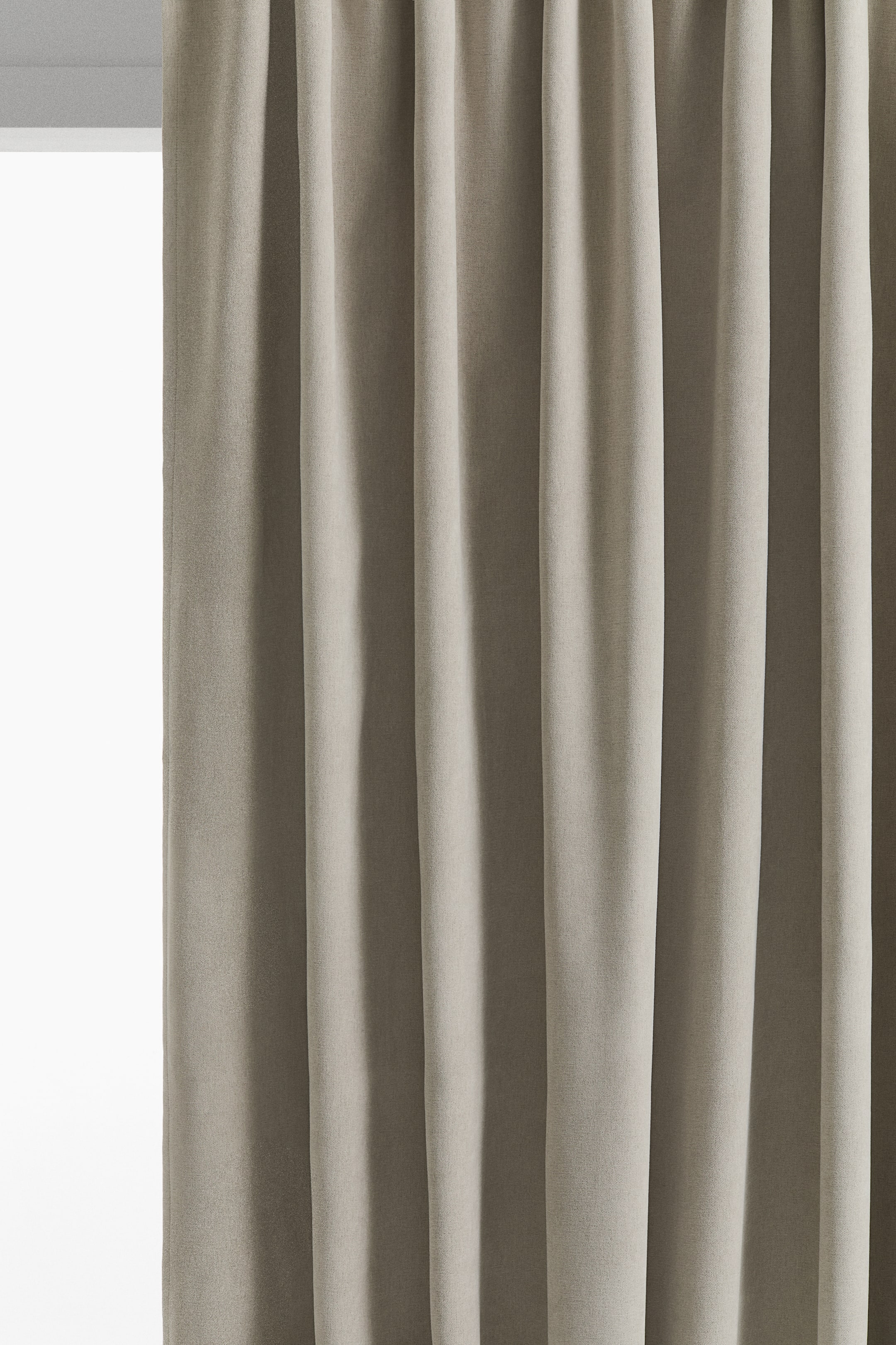 View larger image: A front view of a taupe chenille curtain hanging in soft vertical folds, showcasing the fabric's dense texture and heavy drape.