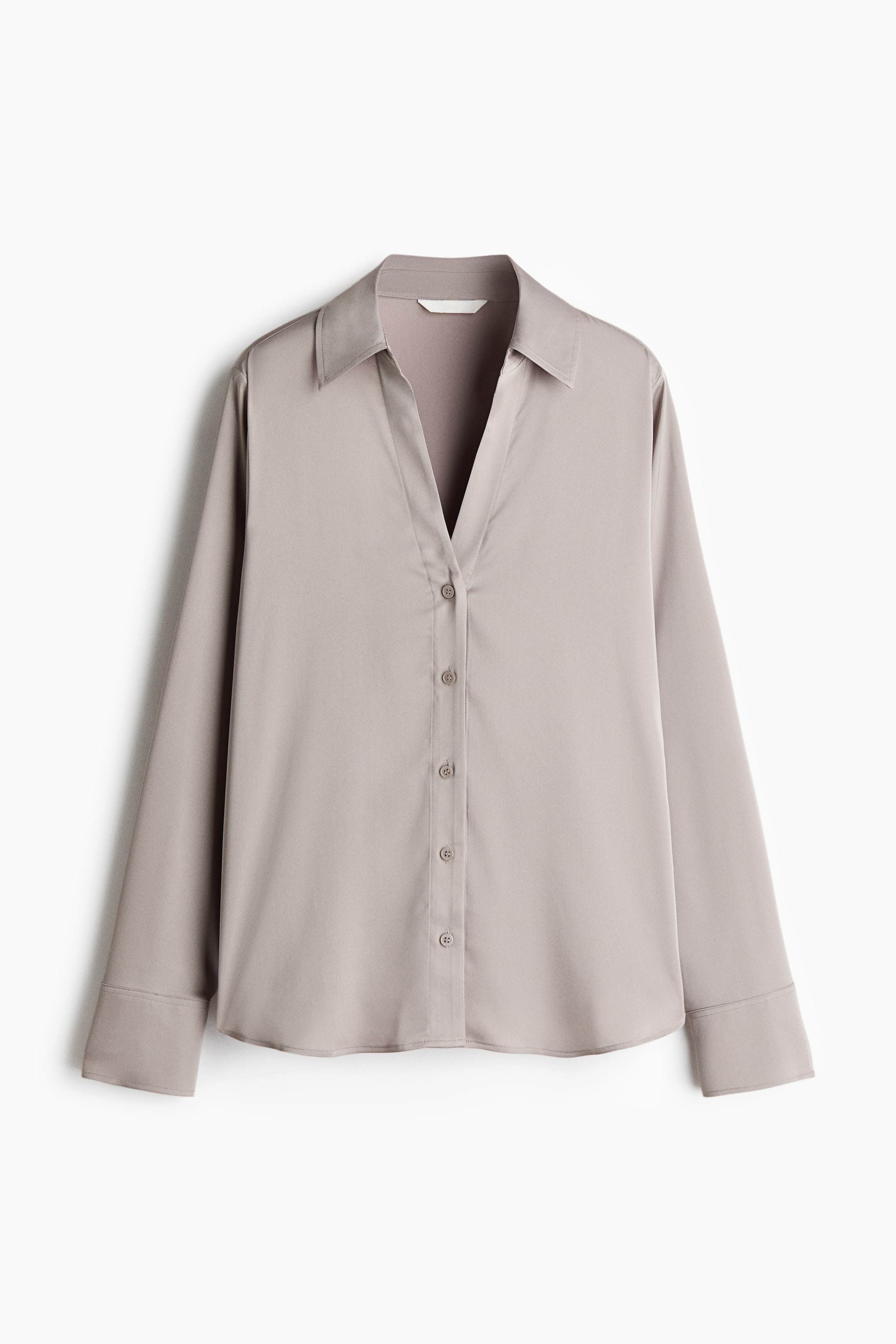 View larger image: A V-neck blouse in woven fabric with a sheen is shown from the front, featuring a collar, front button closure, long sleeves with sleeve plackets and buttoned cuffs, and a rounded hem.