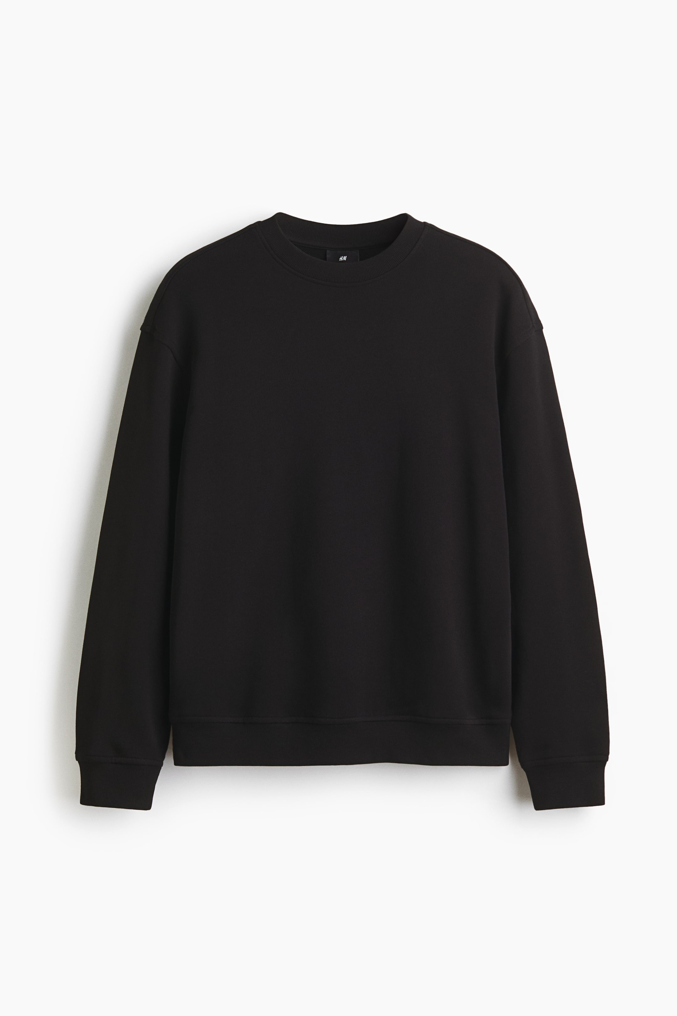 View larger image: A black sweatshirt is shown from the front, featuring a round, rib-trimmed neckline, dropped shoulders, and long sleeves. It is displaying wide, ribbed trim at the cuffs and hem, contributing to its relaxed fit.