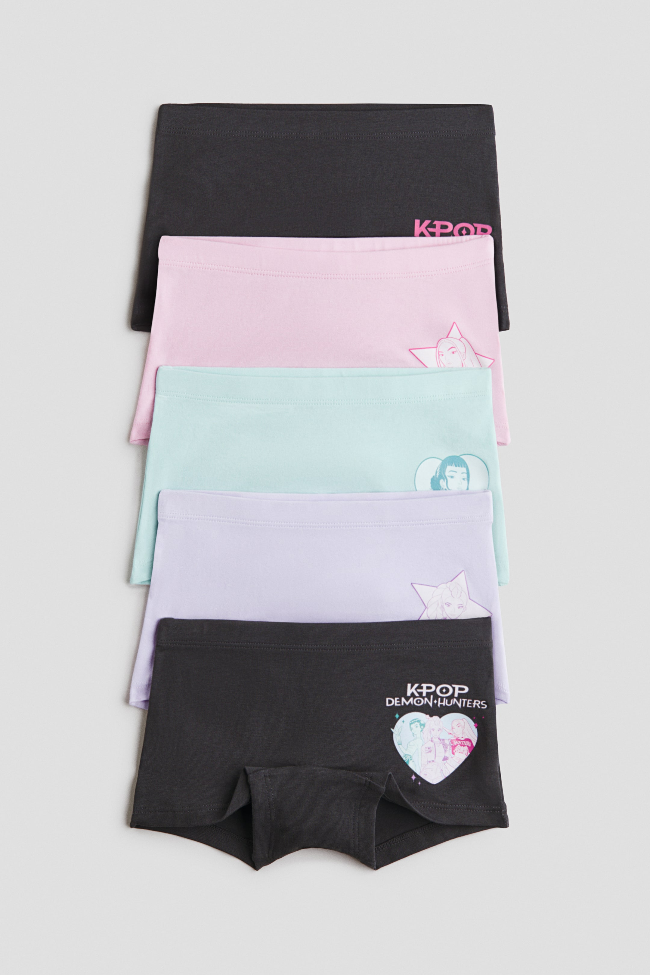 View larger image: Five pairs of boxer briefs in printed cotton jersey are stacked, each facing the front. They feature an elasticated waistband and KPOP-themed graphics, including "KPOP" text and stylised character illustrations. The colours are black, light pink, light blue, light purple, and dark grey.