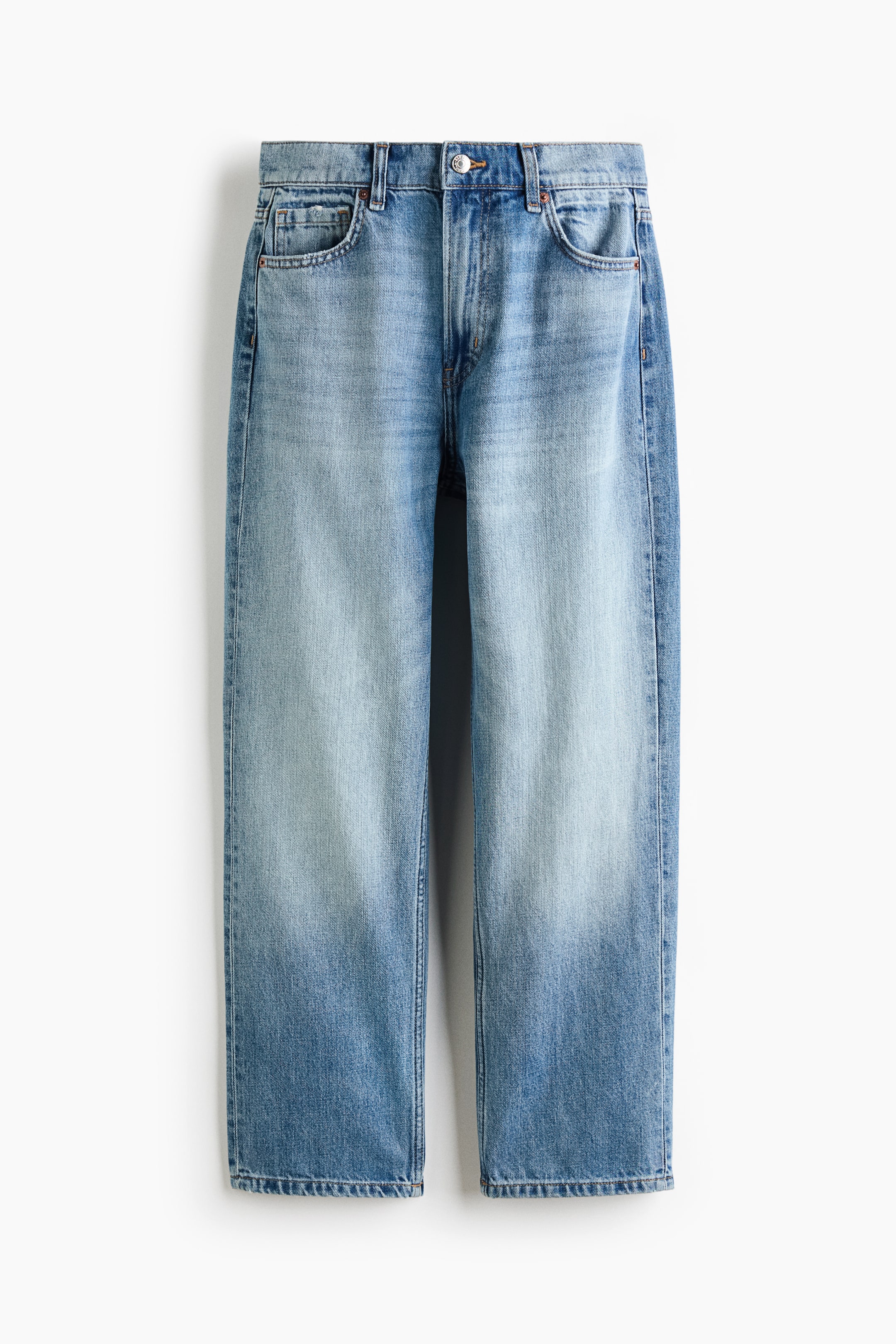 View larger image: A pair of light blue denim jeans is hanging flat, facing front, featuring a faded wash with lighter thighs and darker lower legs, straight-cut hems, a button closure, zipper fly, belt loops, and front pockets.