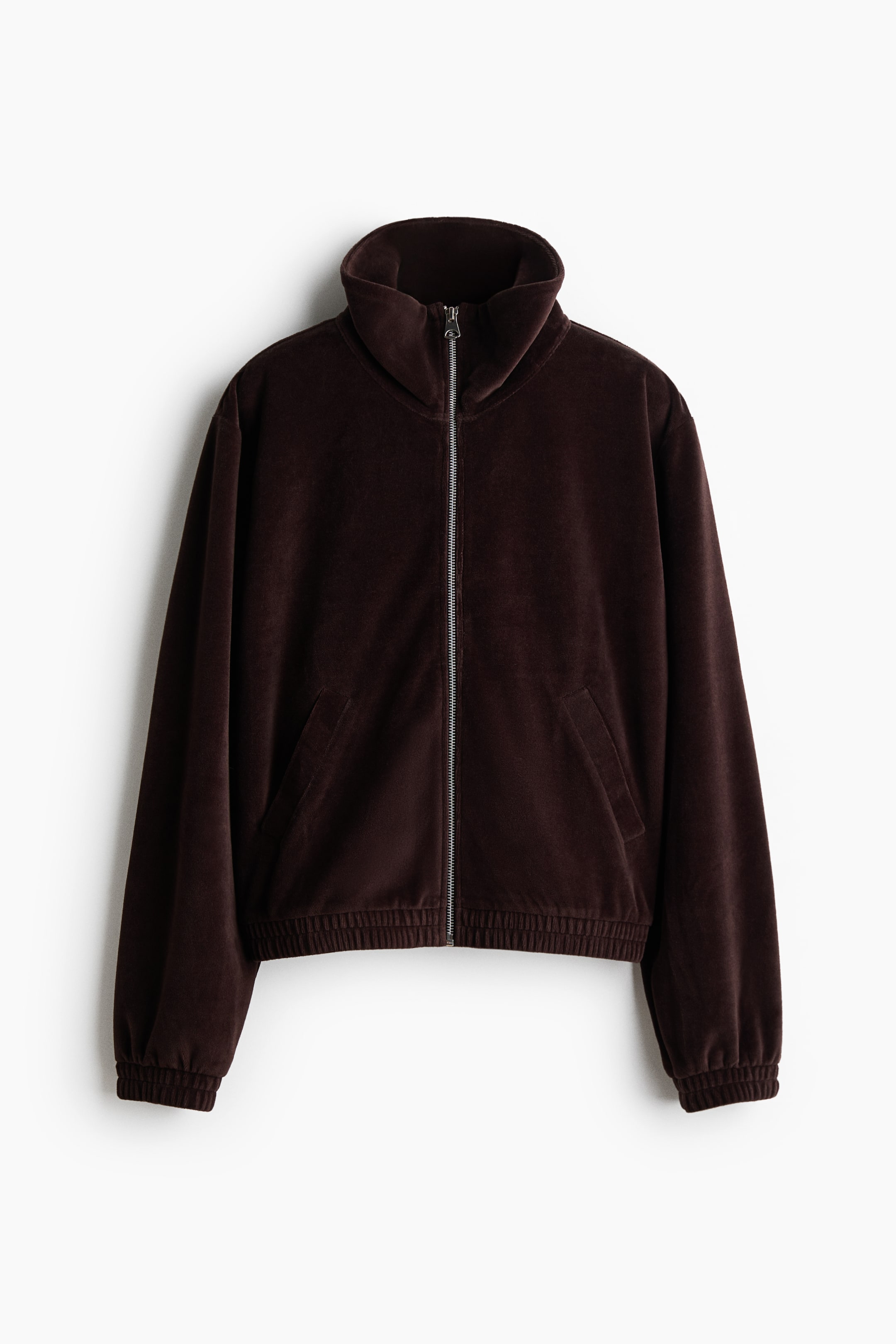 View larger image: A dark brown velvet jacket showcases its front. It features a high stand collar, a full-length silver zipper, two angled welt pockets, and ribbed cuffs and hem.
