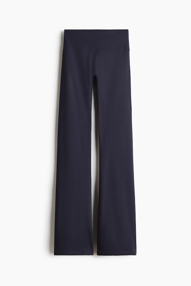 Flared Yoga leggings with SoftMove? are dark navy, featuring a high, wide waistband and a smooth, flared leg design. They are presented flat, facing forward. - 1