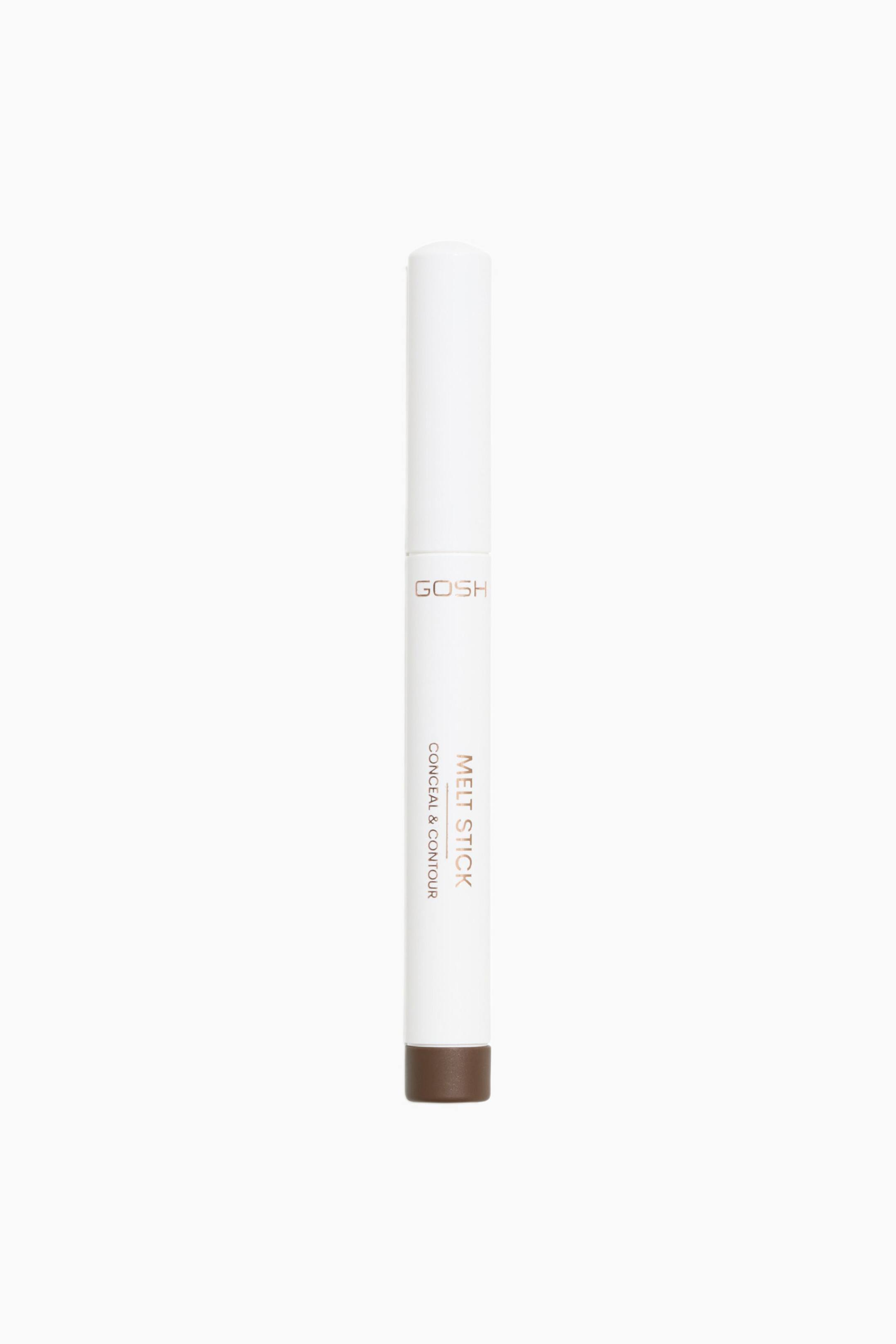 Visa större bild: Melt Stick Conceal & Contour står upprätt och har en smal, cylindrisk vit kropp med matchande lock. Förpackningen pryds av metallisk bronsfärgad text längs sidan och avslutas med en solid brun bas.