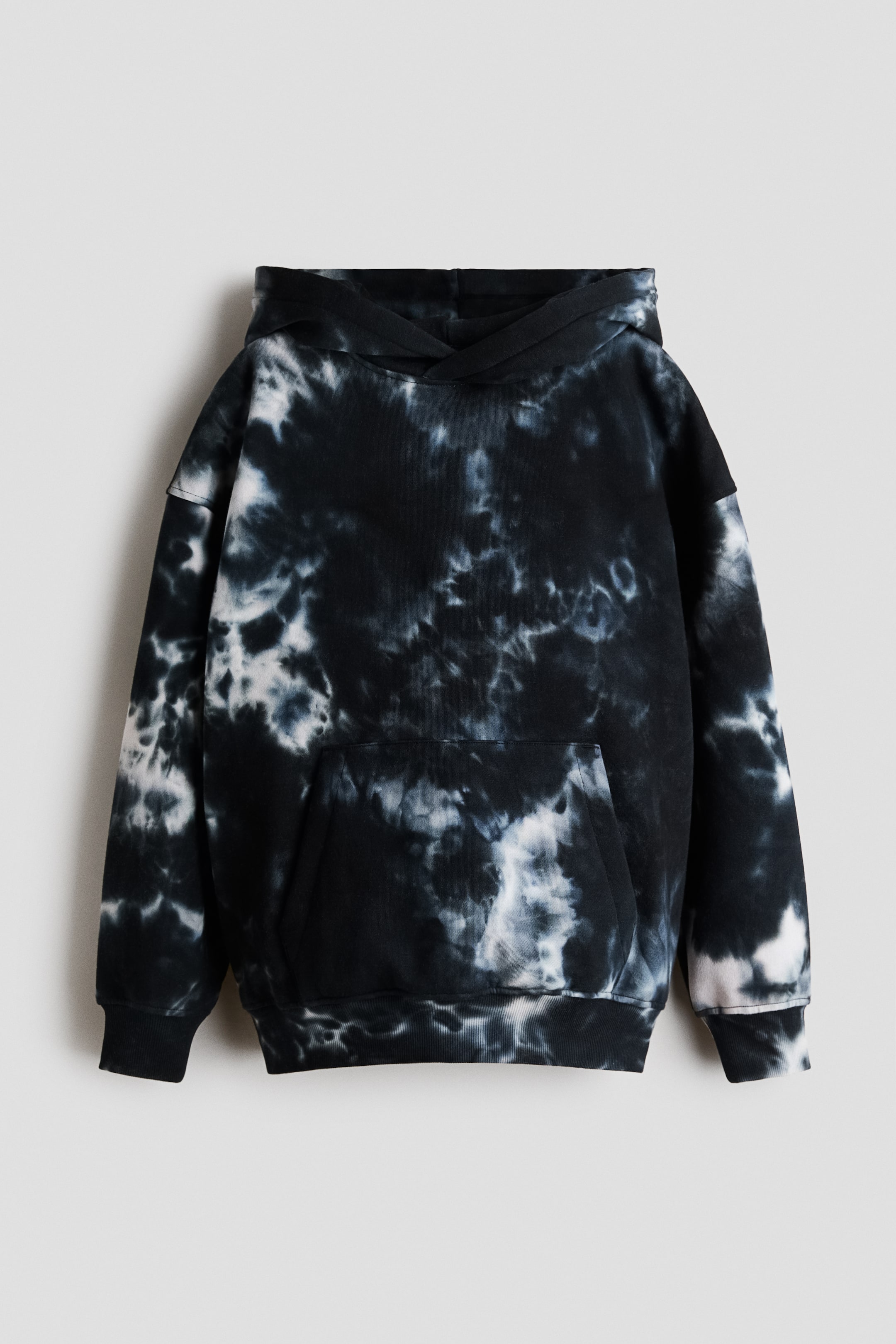 View larger image: The front view of a black and white tie-dye hoodie is showcased. It comes with a hood, a spacious kangaroo pocket, and ribbed cuffs and hem.