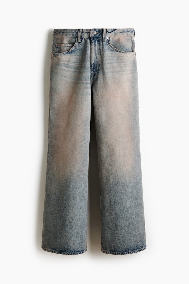 The 5-pocket jeans are displaying from the front, crafted from rigid cotton denim with a faded light blue wash that is lightening on the thighs. They are featuring a regular waist with a zip fly and button closure, and a loose fit from the seat to the hem with a gently flared leg. - 1