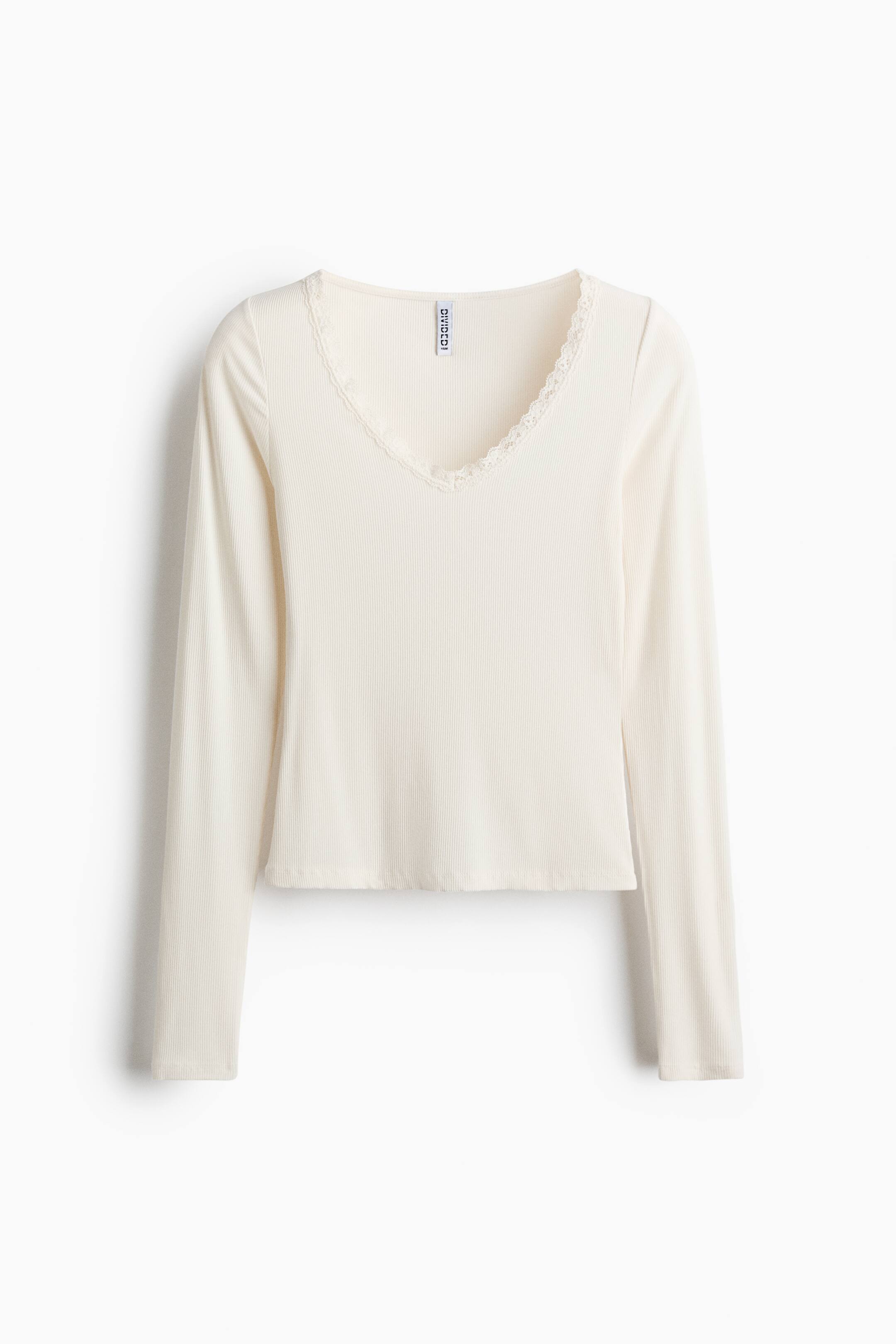 View larger image: A cream long-sleeved fitted top is shown as FRONT, featuring a ribbed-jersey texture and a lace-trimmed V-neckline.