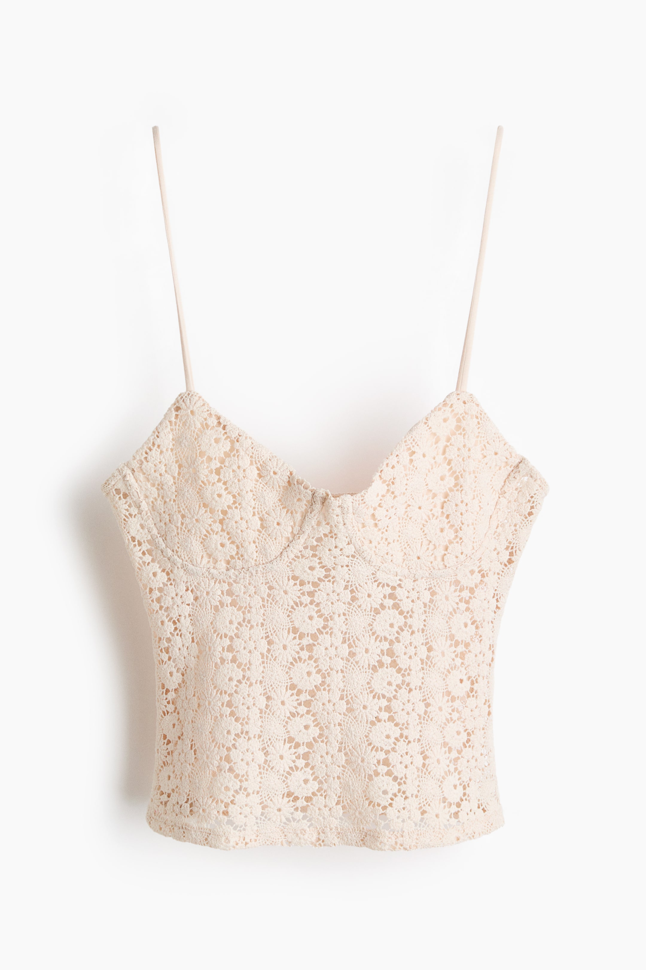 View larger image: A cream crochet lace bustier top is facing front, featuring thin spaghetti straps, a sweetheart neckline, and a structured bust, displaying a floral pattern throughout.