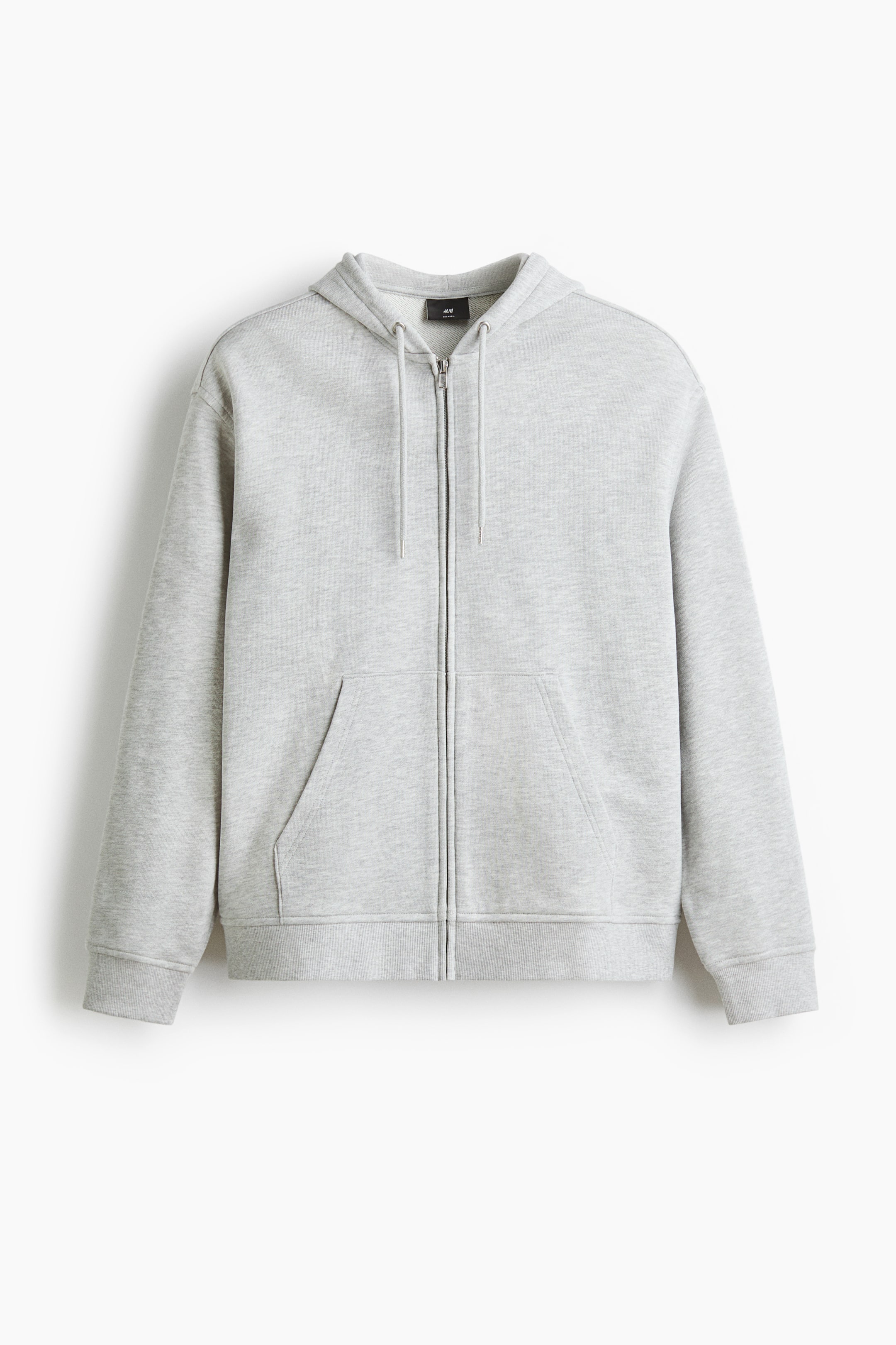 查看大圖: 淺灰色棉質拉鏈連帽衫正面展示，設有抽繩連帽、前面全拉鏈設計及兩個前袋。落肩設計勾勒出輪廓，長袖延伸至羅紋袖口，羅紋下擺完美收尾，整體呈現輕鬆休閒的版型。