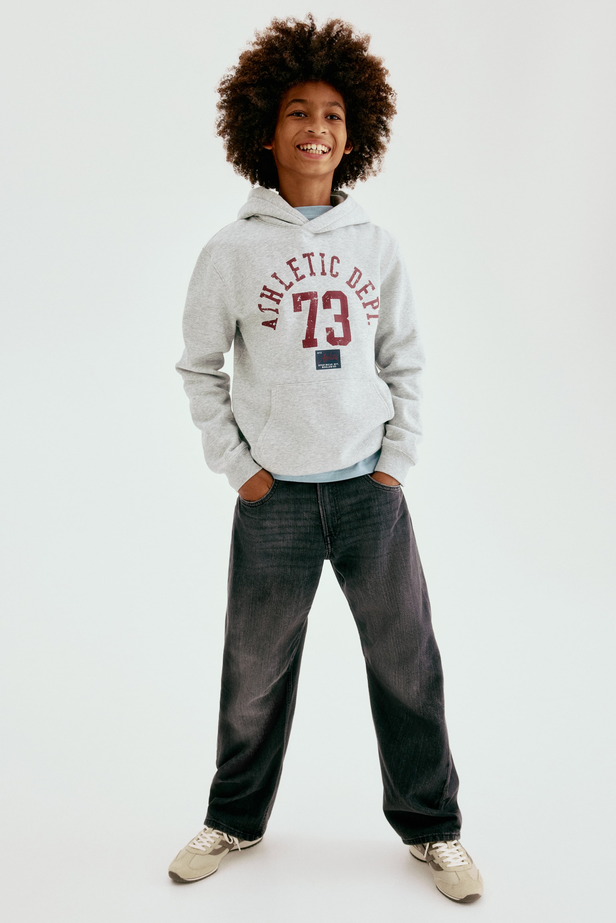 View larger image: Front-facing 5-pocket jeans in dark wash cotton denim are presenting a loose fit through the hip and thigh, with barrel legs. The jeans are featuring a faded wash on the thighs, and the wearer's hands are resting in the front pockets.
