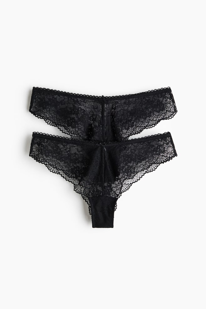 Two pairs of black lace briefs are presenting their front view, featuring a low waist, a lined gusset, and a high cut at the back. - 1