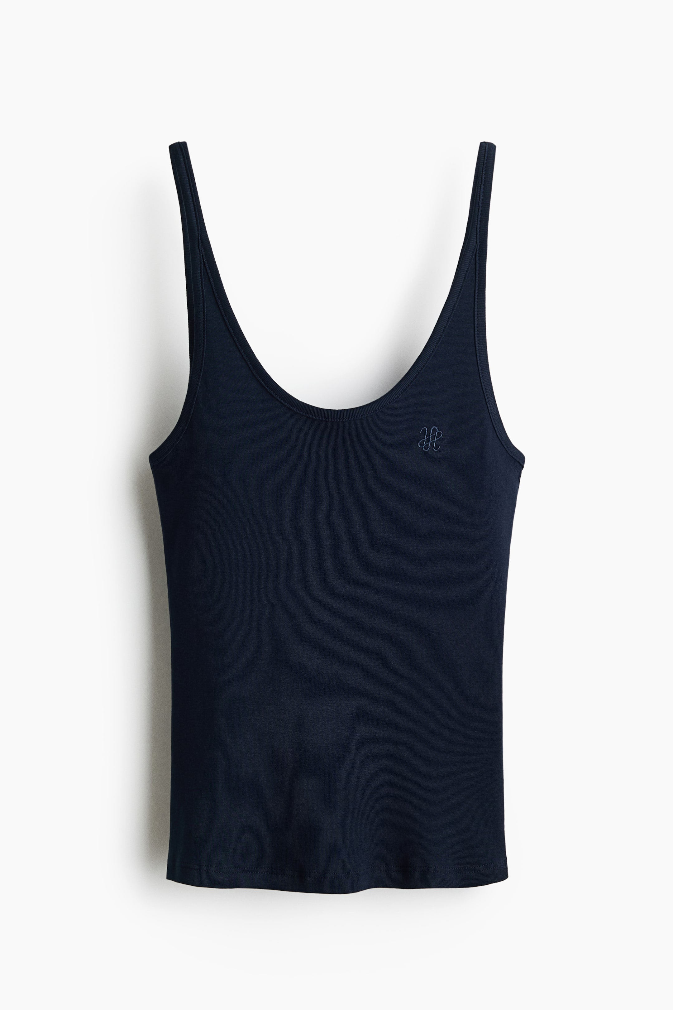 View larger image: A fitted navy blue cotton jersey vest top is being showcased from the front. It highlights a scoop neckline, slim shoulder straps, and a small embroidered motif on the front.