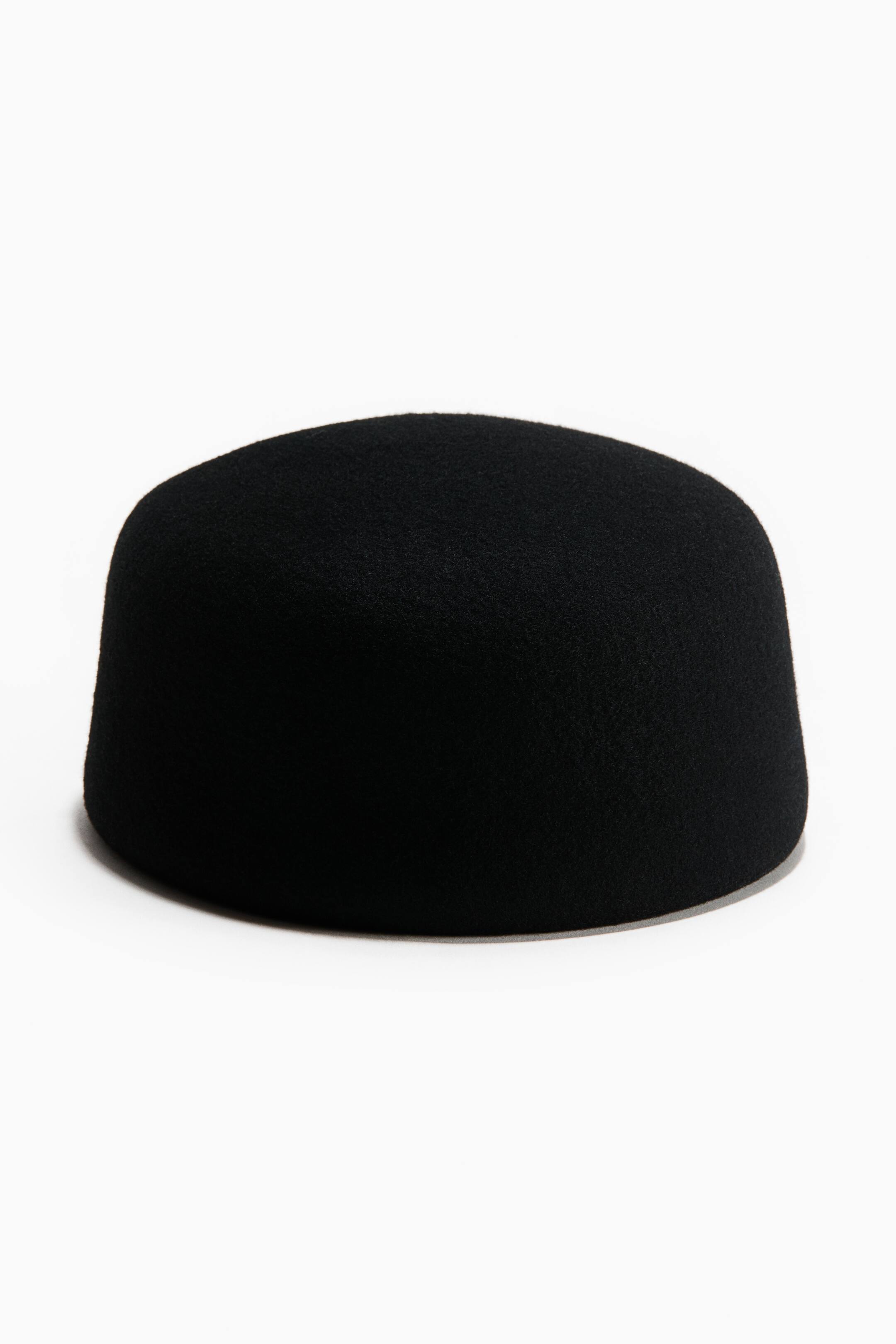 View larger image: A black felt hat featuring a short, straight-sided form with a rounded top, presented from a front angle.