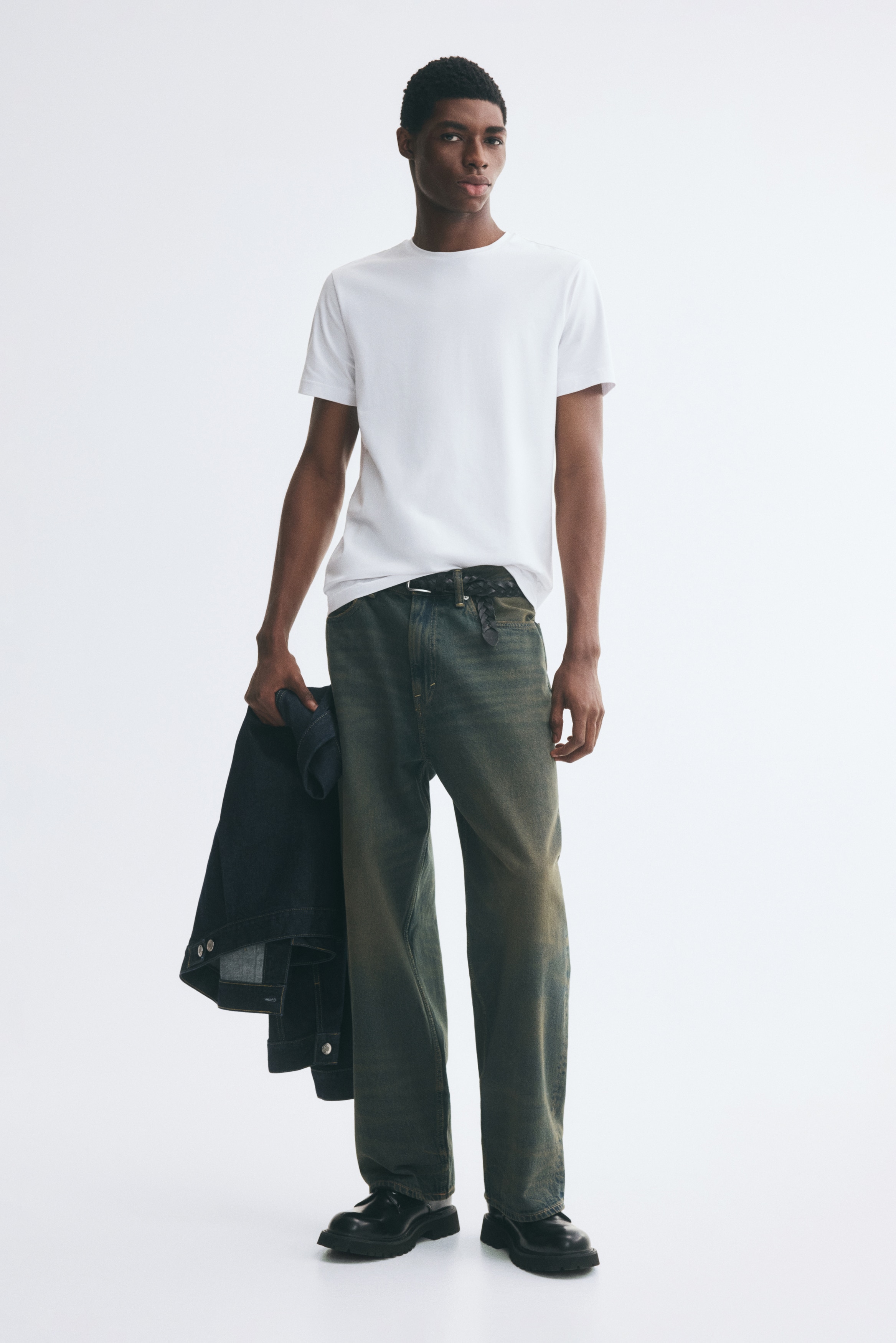 A white crew-neck T-shirt is facing front, featuring short sleeves, a ribbed collar, and a straight hem.