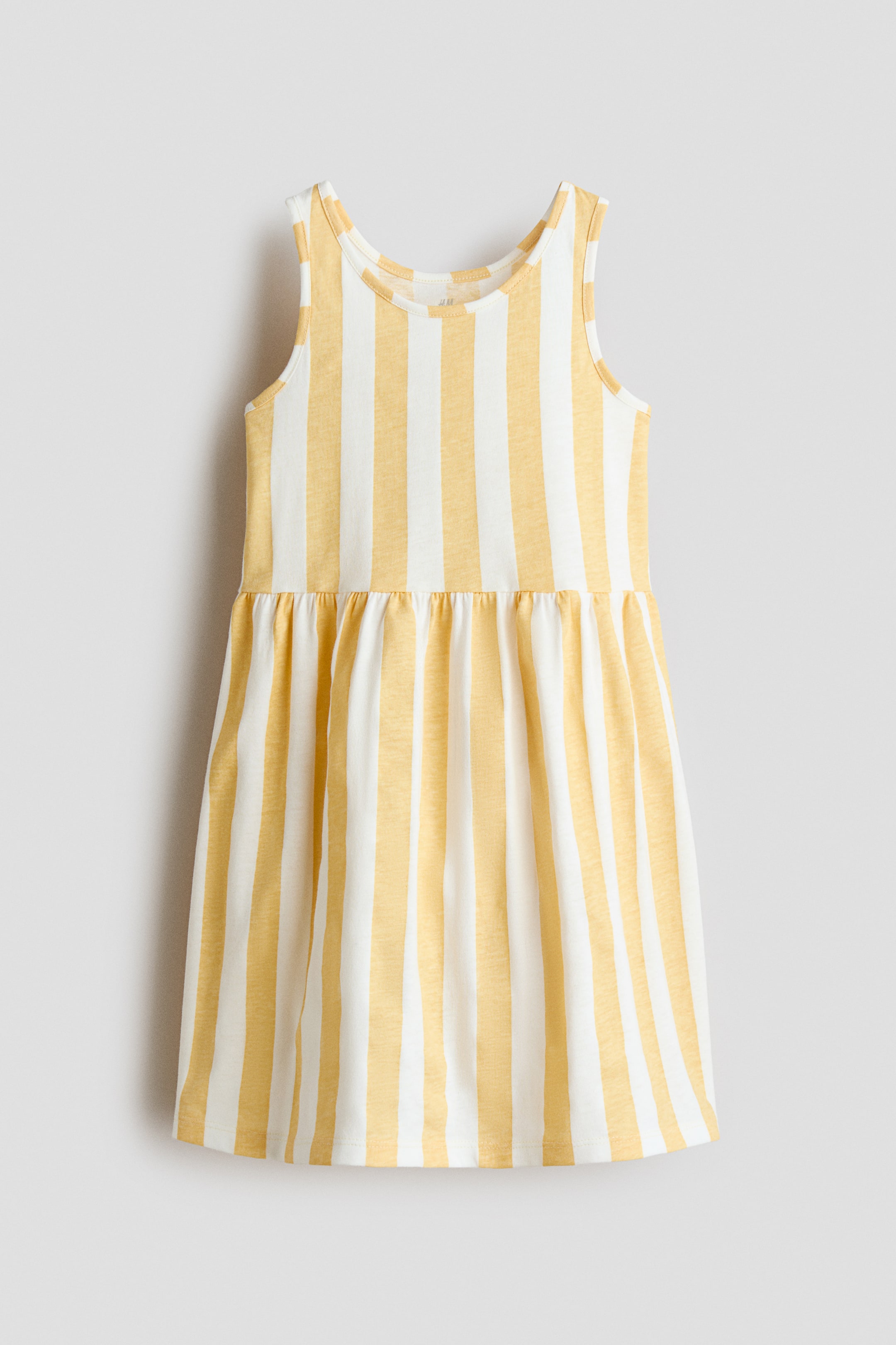 View larger image: A sleeveless dress crafted in soft cotton jersey, adorned with an all-over pattern of yellow and white vertical stripes. It features a round neckline, a gathered seam at the waist, and a flared skirt, elegantly showcasing its front.