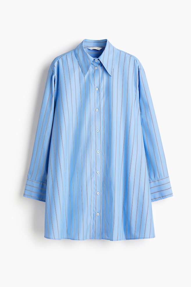 A short, oversized dress is presented in a FRONT view, featuring light blue woven fabric with thin black and white vertical stripes. It is designed with a pointed collar, white buttons down the front, gently dropped shoulders, and long sleeves with buttoned cuffs, forming an A-line silhouette. - 1