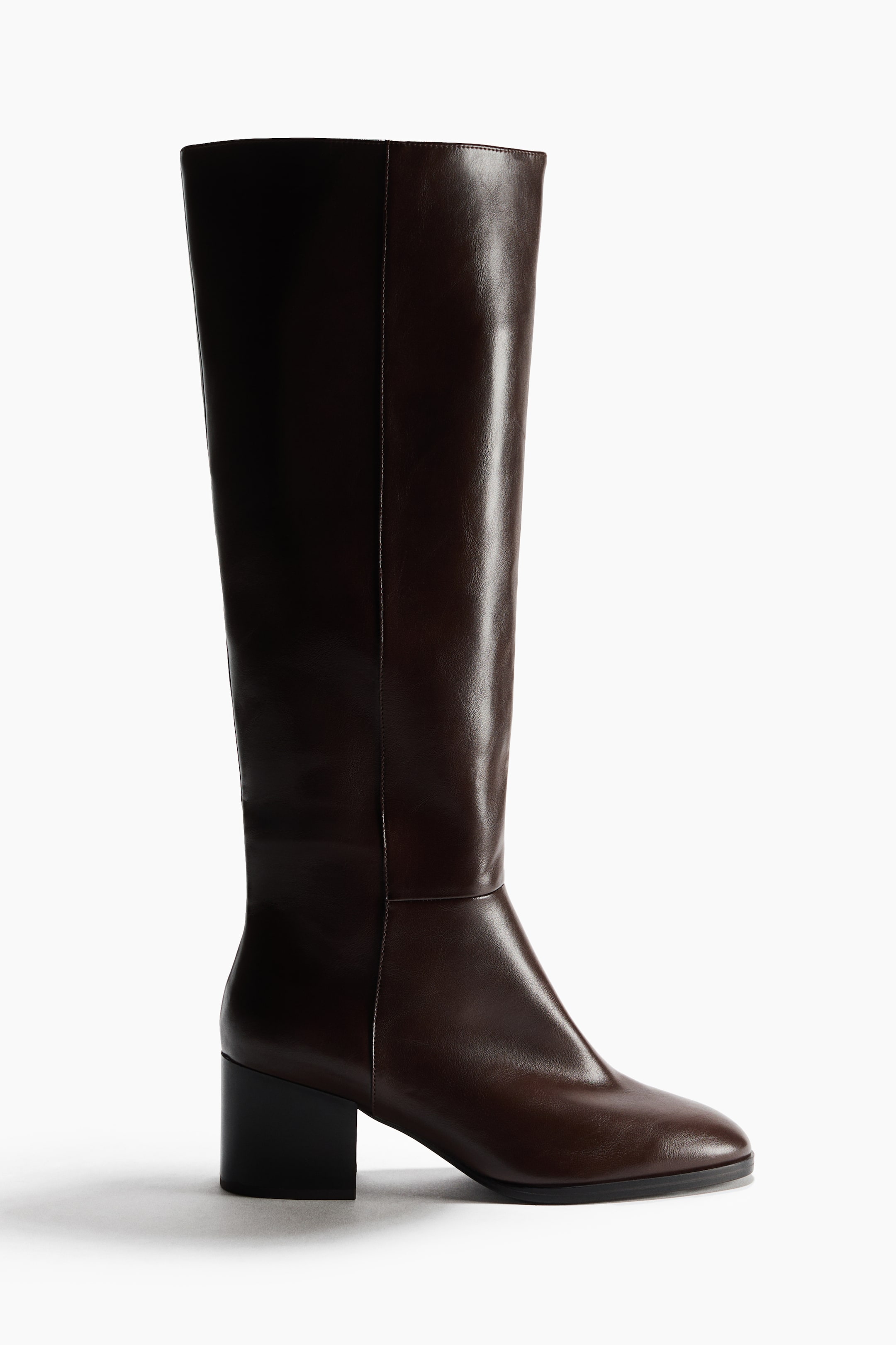 View larger image: A dark brown boot is standing, showcasing a knee-high shaft, a rounded toe that faces slightly forward, and a black block heel.
