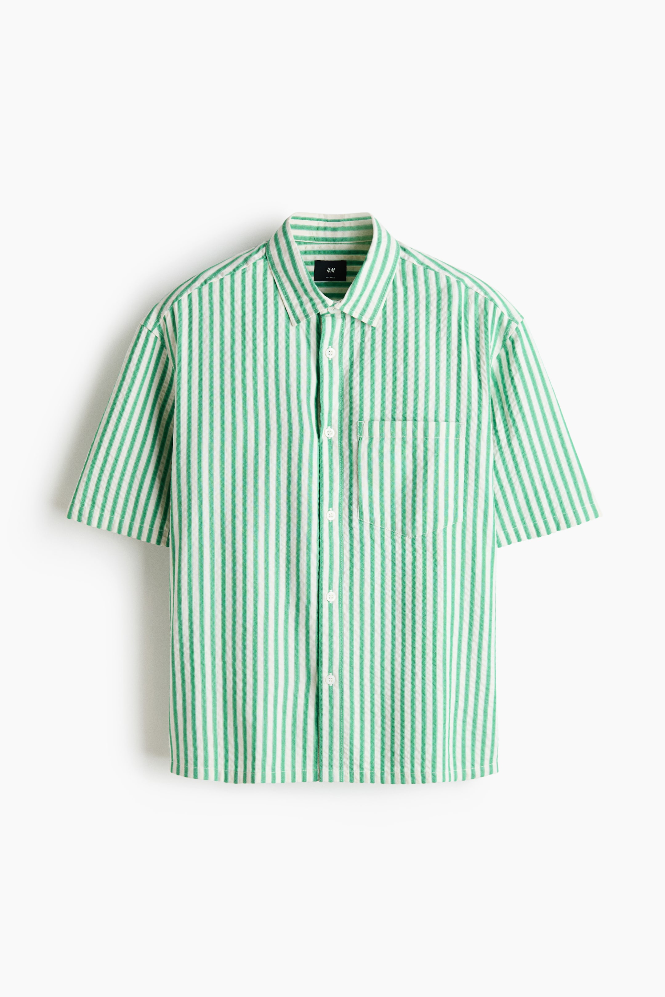 View larger image: A short-sleeved shirt is showcased front-facing, featuring vertical green and white seersucker stripes. It is crafted with a pointed collar, a full button-front closure with white buttons, and a single patch pocket on the left chest.