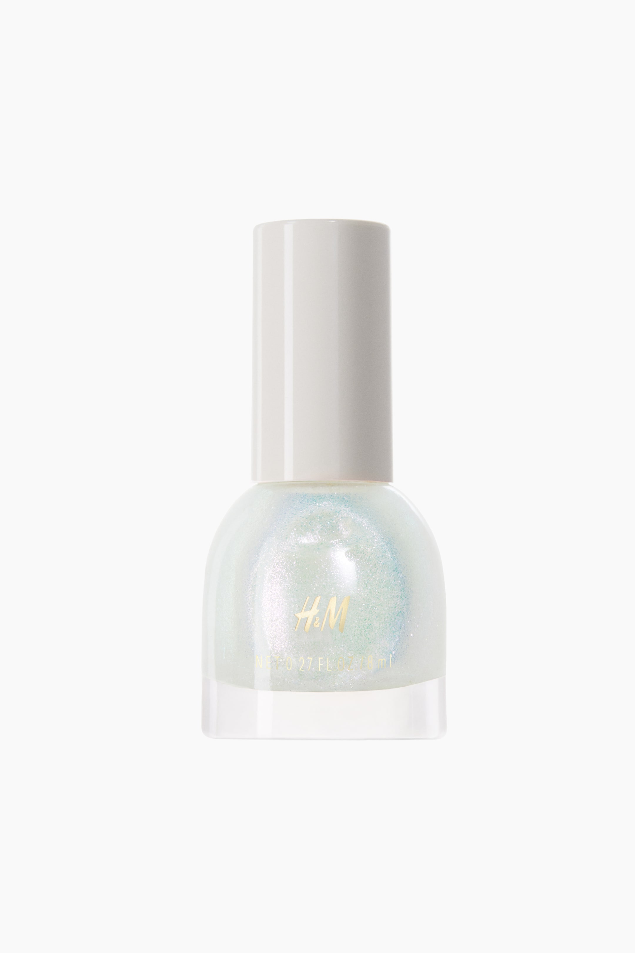 View larger image: The nail polish bottle is positioned facing forward, showcasing a transparent glass body brimming with iridescent, shimmering polish that transitions between light blue, green, and pink shades. A solid white cylindrical cap securely seals the bottle, with a gold "H&M" logo prominently displayed on the front.