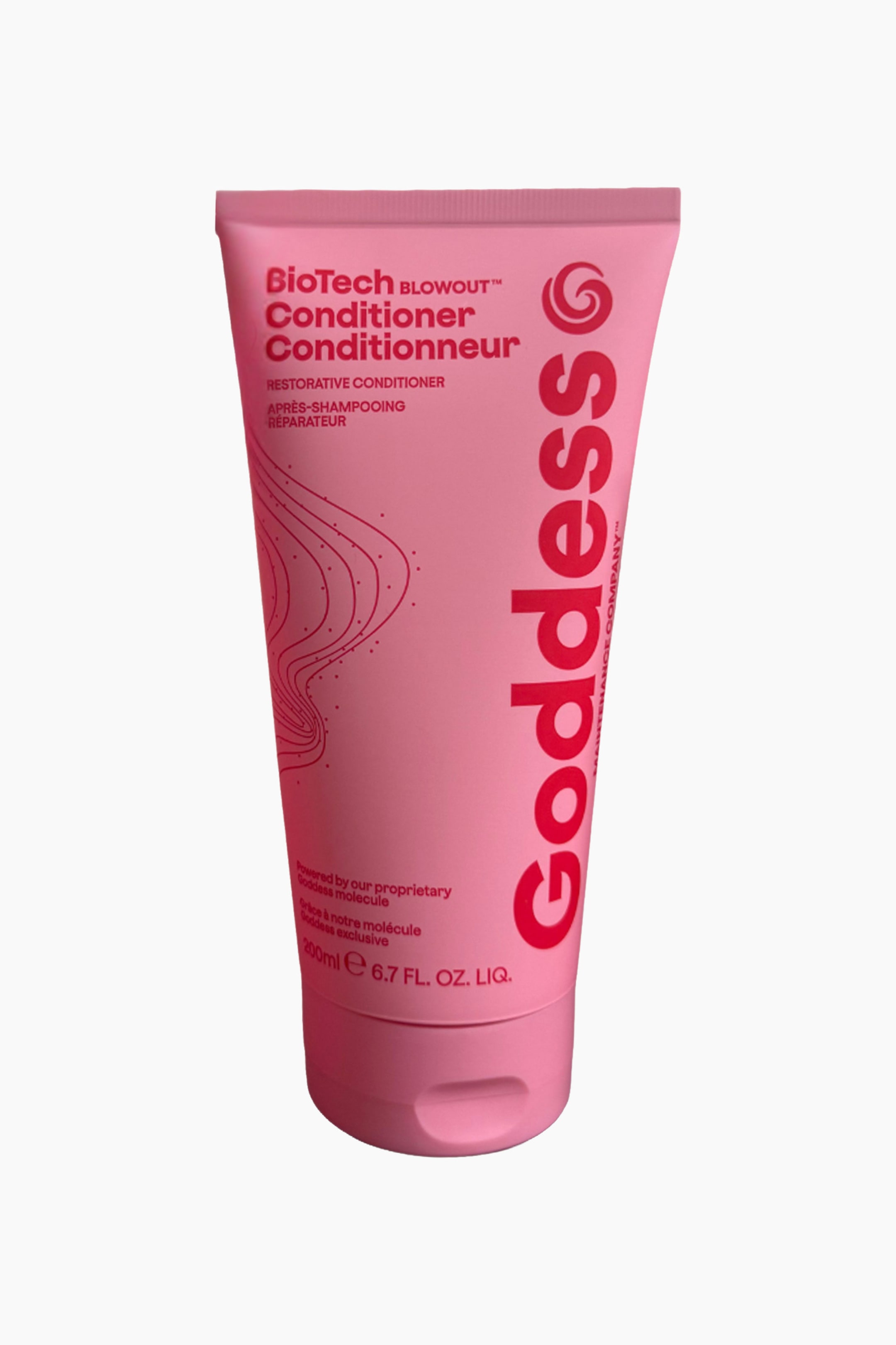 Visa större bild: En rosa klämtub för balsam står upprätt, något vinklad åt höger och visar 'BioTech BLOWOUT? Conditioner' och 'Goddess'-märkning i röd text, tillsammans med virvlande röda linjer och prickar på framsidan samt ett platt, gångjärnsförsett lock i botten.