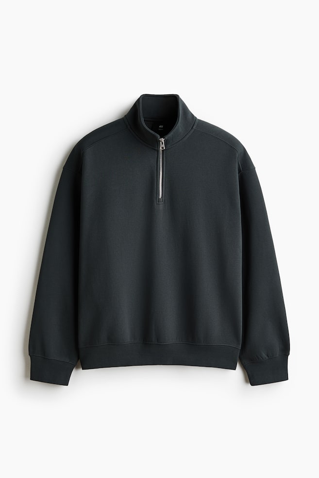 A dark gray quarter-zip sweatshirt is facing front, featuring a stand-up collar and a silver quarter-zip closure. It is displaying a relaxed fit with dropped shoulders, long sleeves with ribbed cuffs, and a ribbed hem. - 1