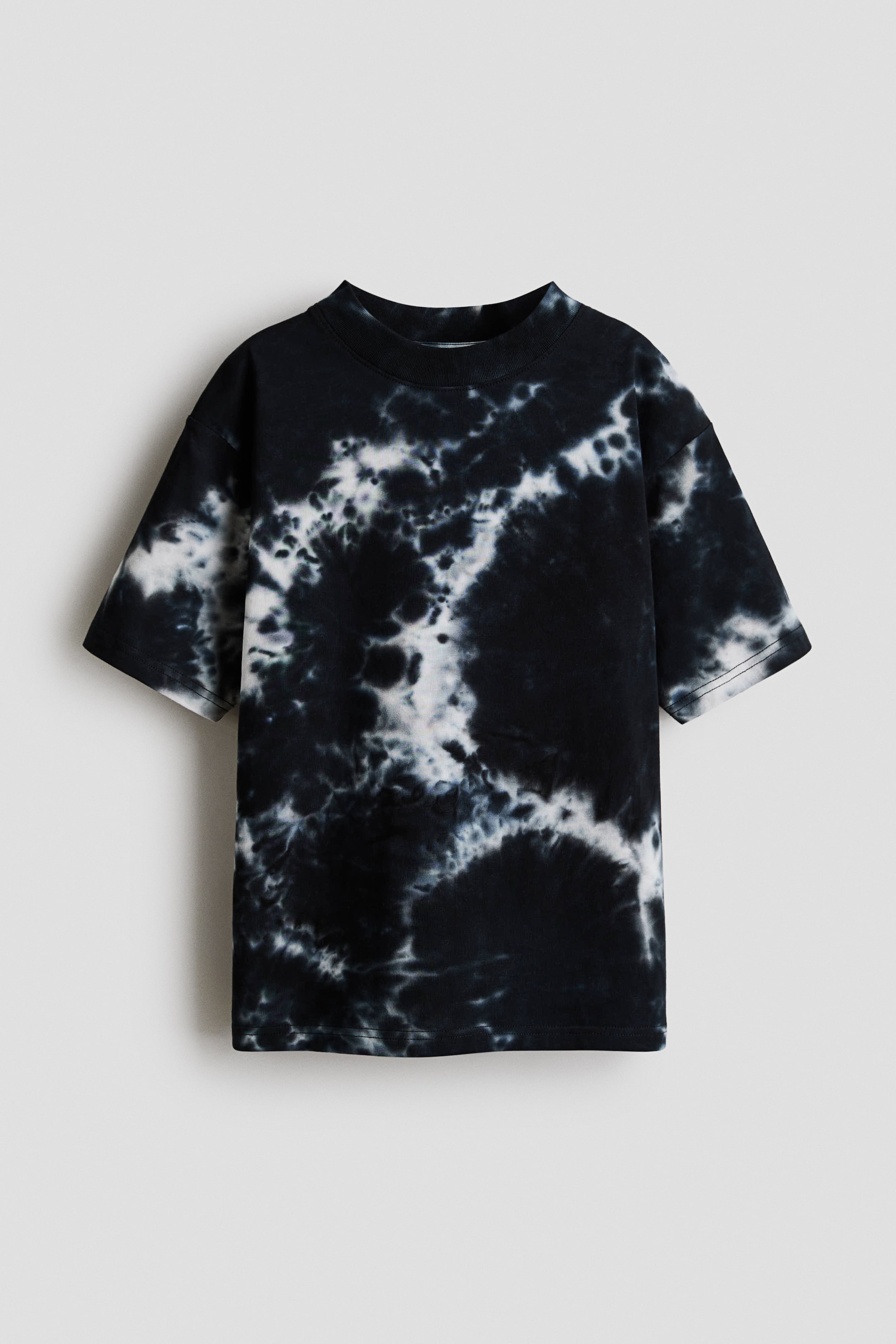 View larger image: "A t-shirt is showing its front view, showcasing a black and white tie-dye pattern with a marbled effect. It is crafted with a relaxed fit, a round neckline with ribbed trim, and subtly dropped shoulders."