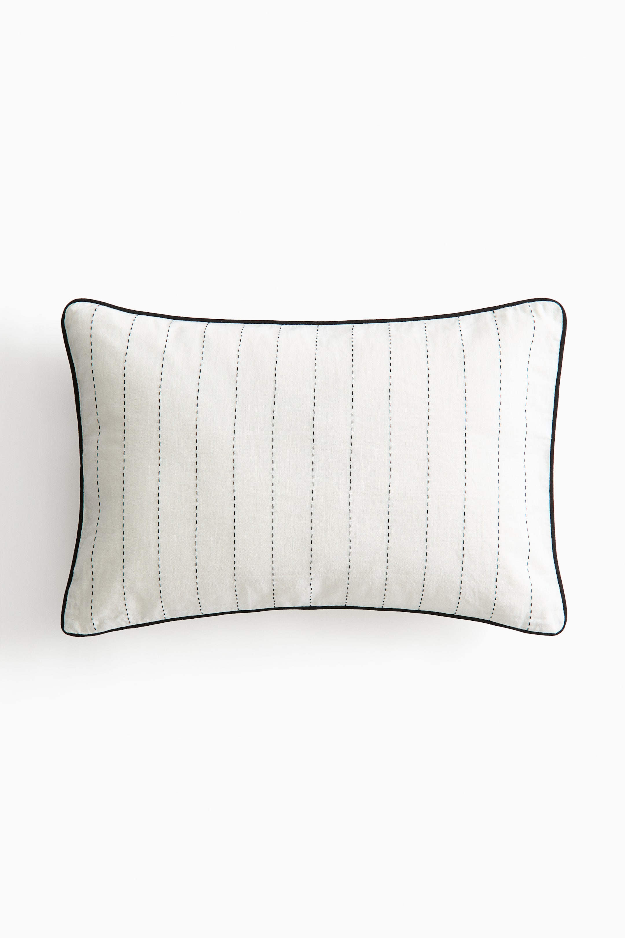 View larger image: The cushion cover is rectangular and displayed front-facing. Crafted from a linen and cotton blend canvas, it showcases vertical dashed accent-color stitching and accent-color piping along the edges. Designed with a concealed zipper on one side.