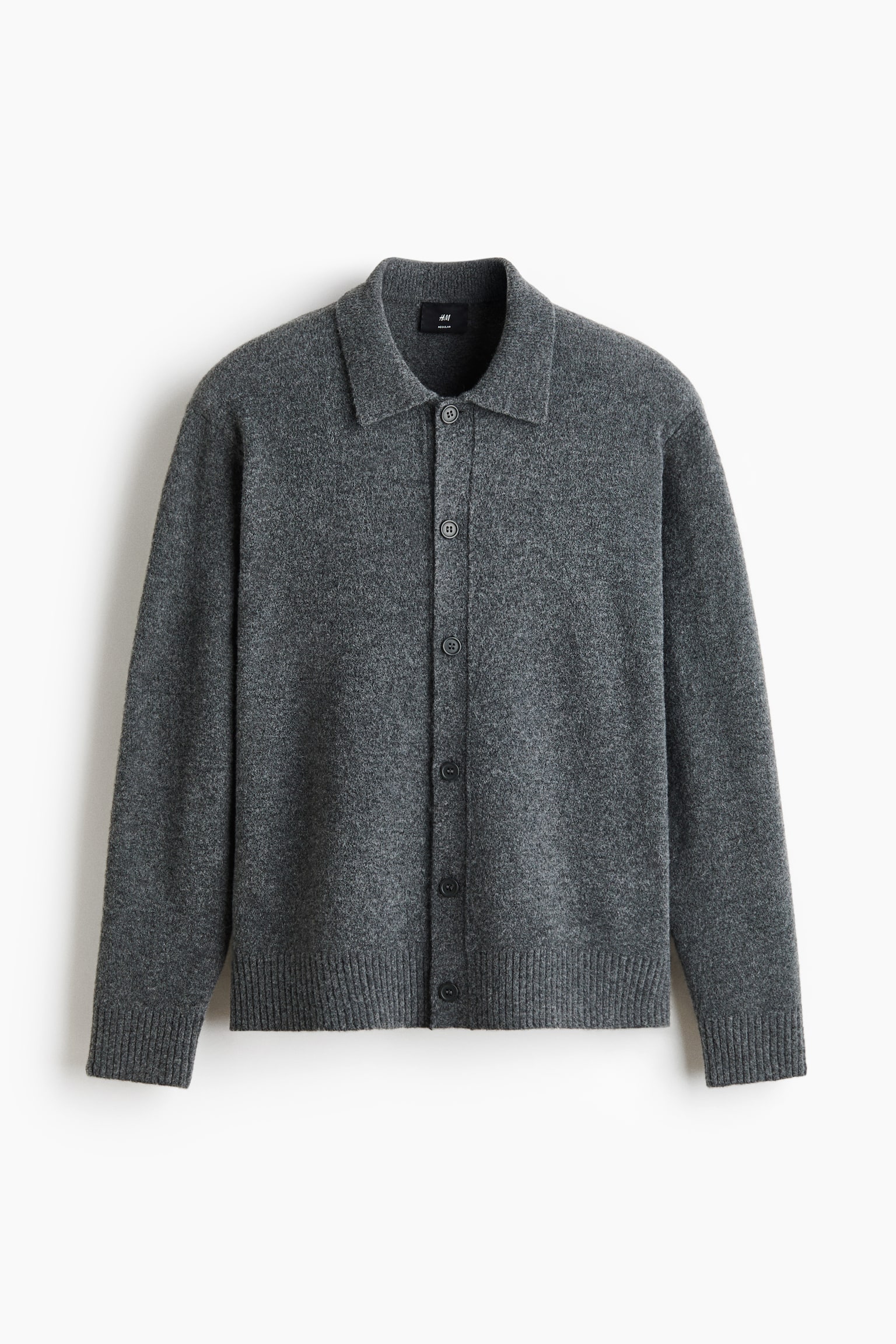 A dark grey knitted cardigan is displayed front-facing, featuring a classic spread collar, five dark buttons down the center, and ribbed cuffs and hem.