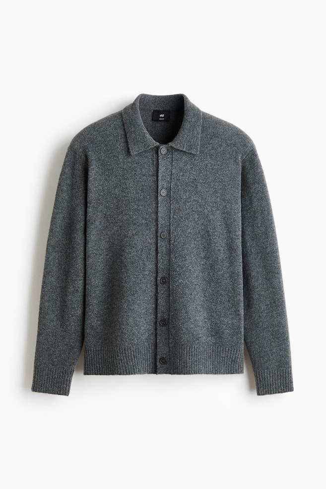 A dark grey knitted cardigan is presented front-facing, featuring a classic spread collar, five dark buttons down the centre, and ribbed cuffs and hem. - 1