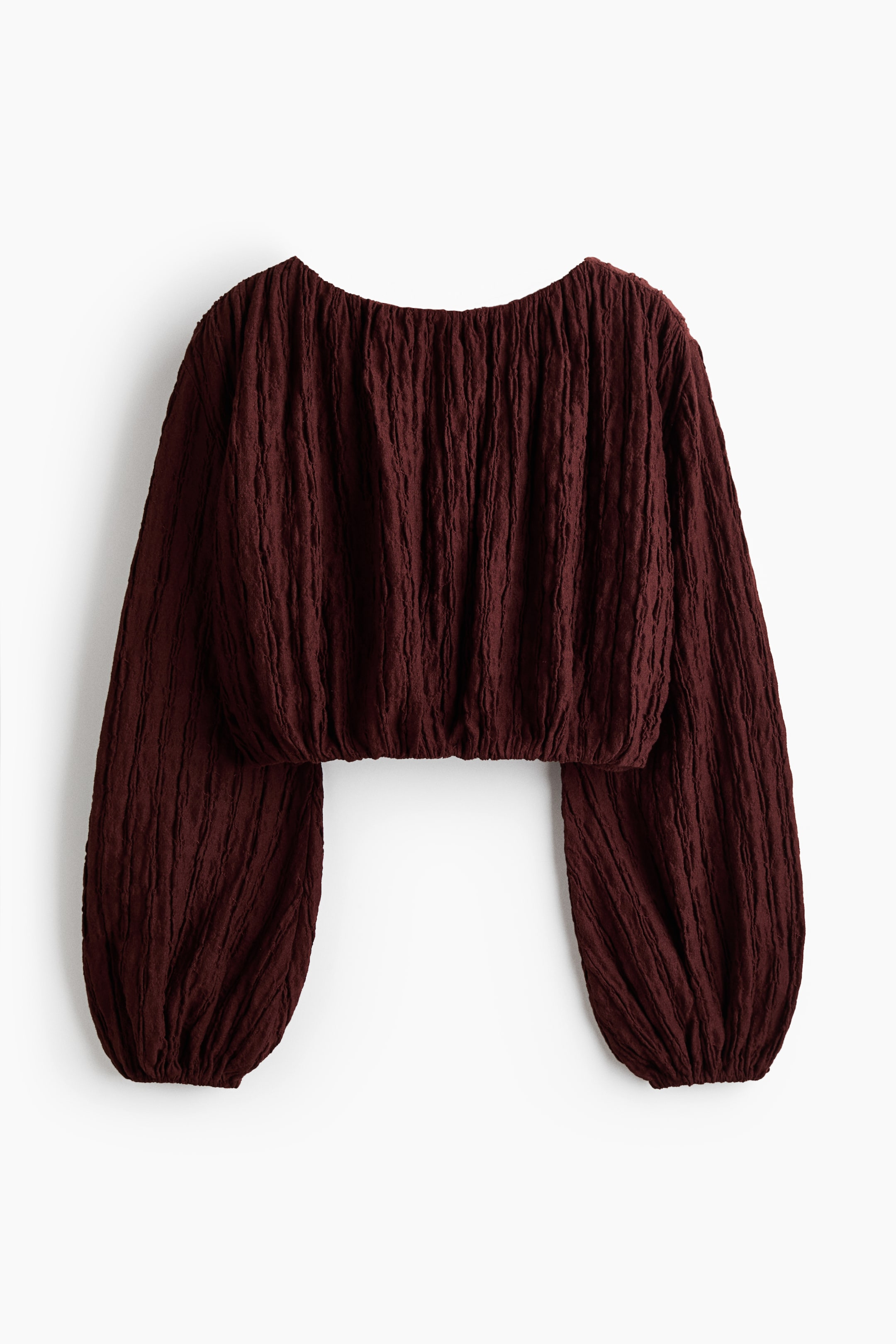 View larger image: The dark red long-sleeved top is front-facing, highlighting a crinkled texture throughout its fabric. It features a wide rounded neckline and voluminous balloon sleeves that gather at the elasticated cuffs and cropped hem.