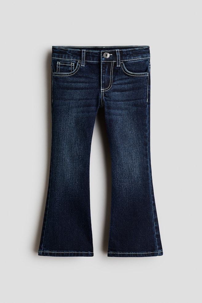 These dark wash flare jeans are displayed in a front-facing view, featuring a classic five-pocket design with light-coloured contrast topstitching and a single metal button closure. The denim shows subtle fading along the thighs before widening into a flared leg silhouette at the hem. - 1