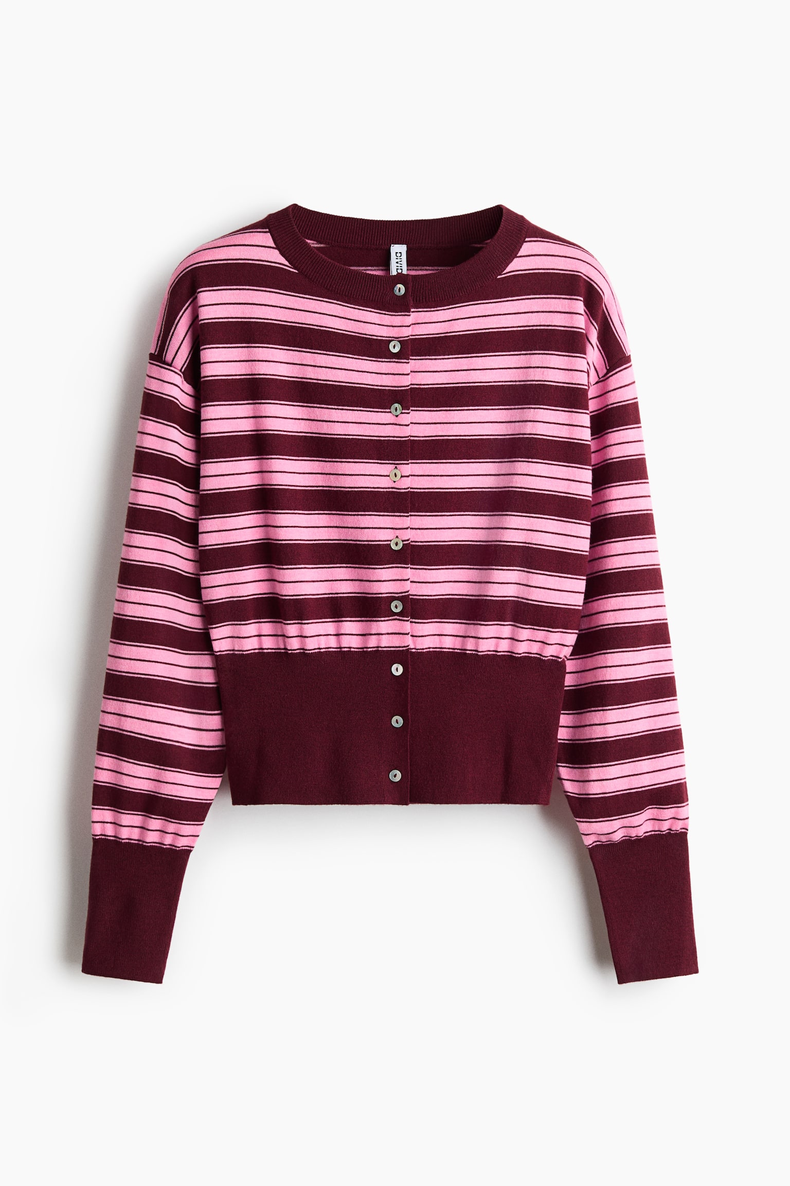 En stickad kofta visas framifrÃ¥n och har horisontella rosa och vinrÃ¶da rÃ¤nder Ã¶ver kroppen och de lÃ¥nga Ã¤rmarna. Modellen har en rund halsringning, en knÃ¤ppning framtill med knappar samt en bred, enfÃ¤rgad vinrÃ¶d ribbad nederkant och ribbade Ã¤rmslut. - 1