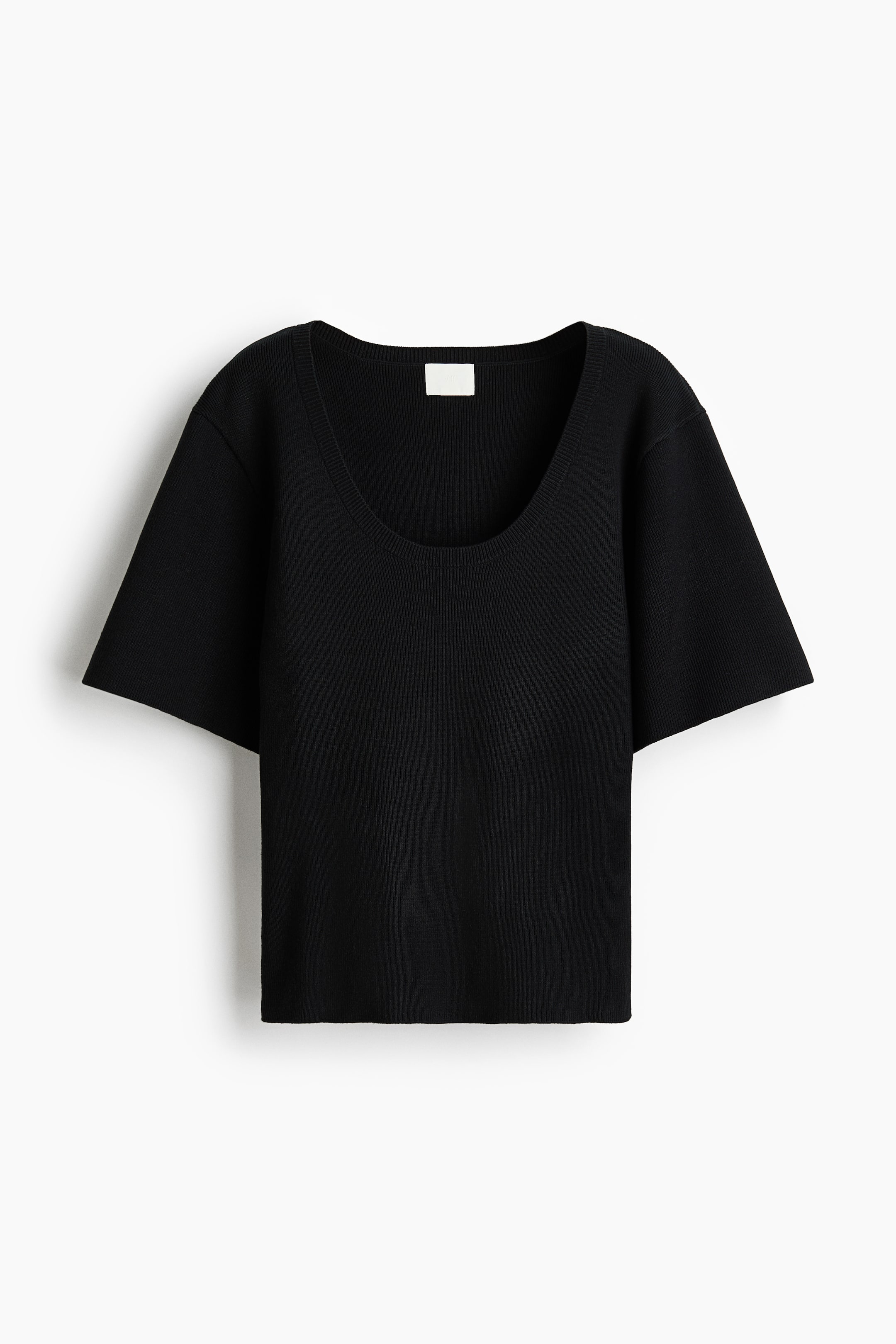 View larger image: The black fitted t-shirt is seen from the front, featuring a fine ribbed knit, a rib-trimmed scoop neckline, dropped shoulders, and short, wide sleeves.