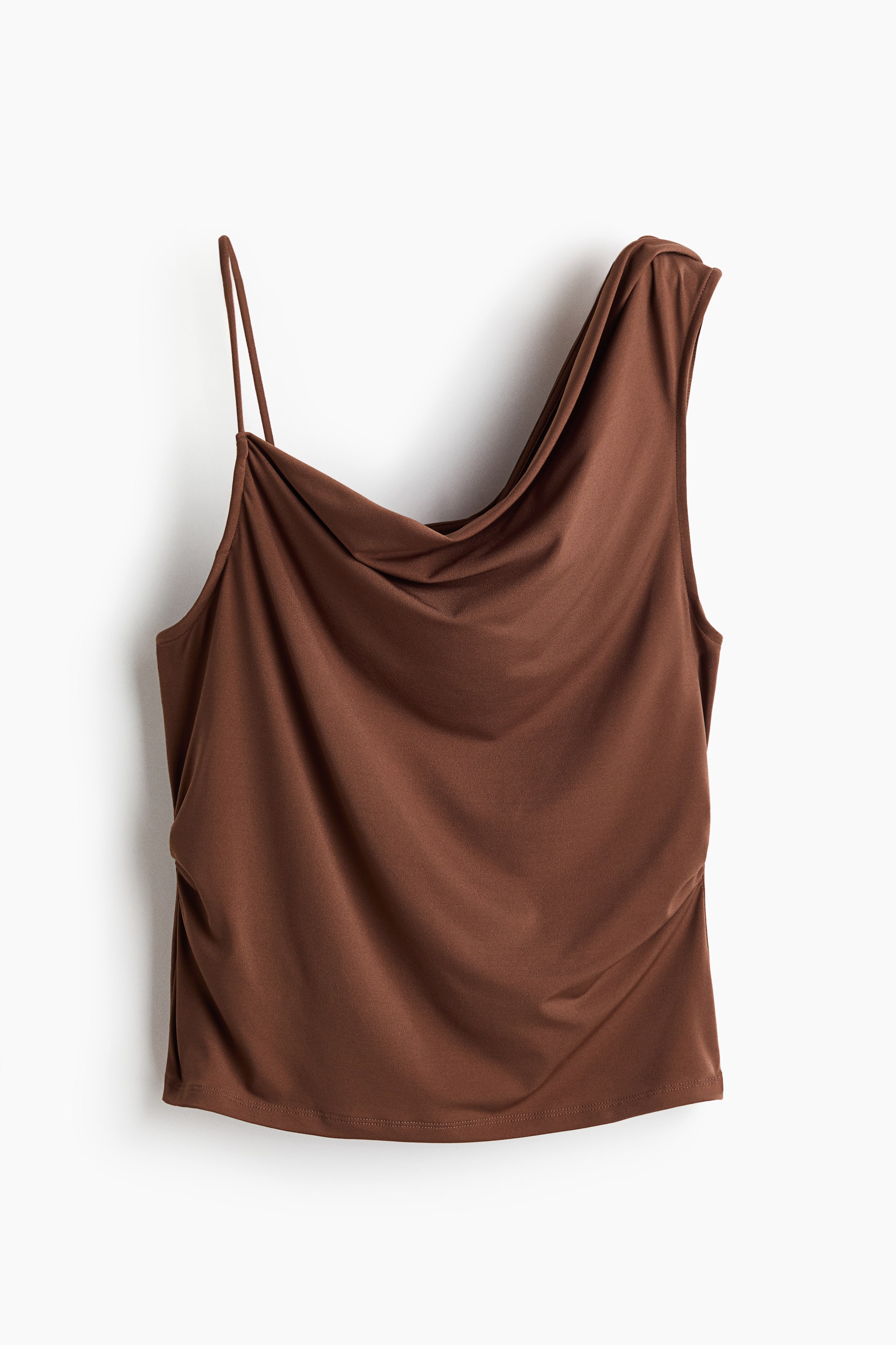 View larger image: A brown asymmetrical top features a thin spaghetti strap on the left and a draped cowl neckline on the right. The smooth fabric gathers vertically on the left side of the bodice.
