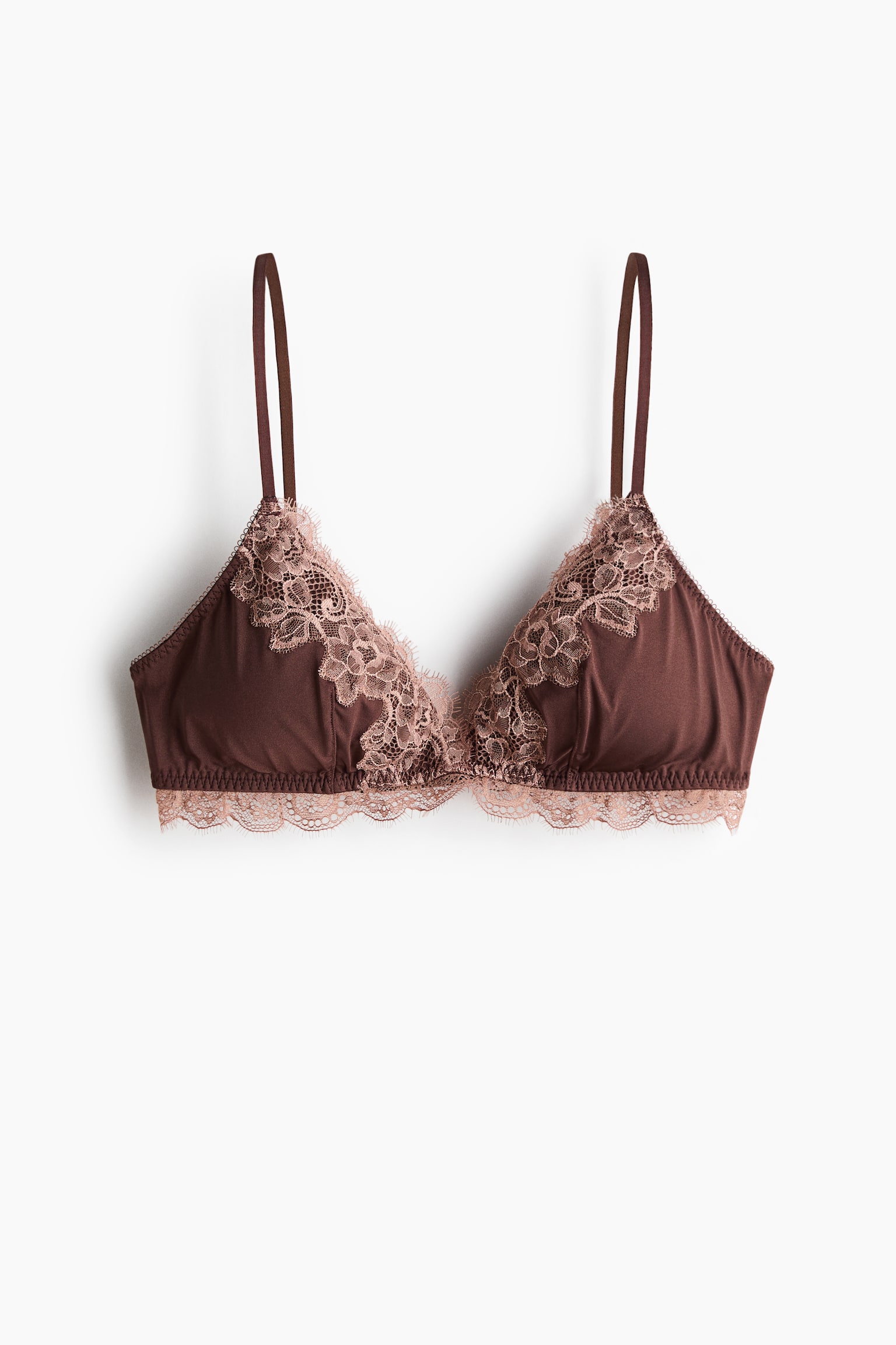A dark brown bralette featuring triangular soft cups with delicate peachy-pink floral lace detailing. The lace extends along the top edges of the cups, forming a scalloped trim along the bottom band, while thin shoulder straps are visible at the top. - 1