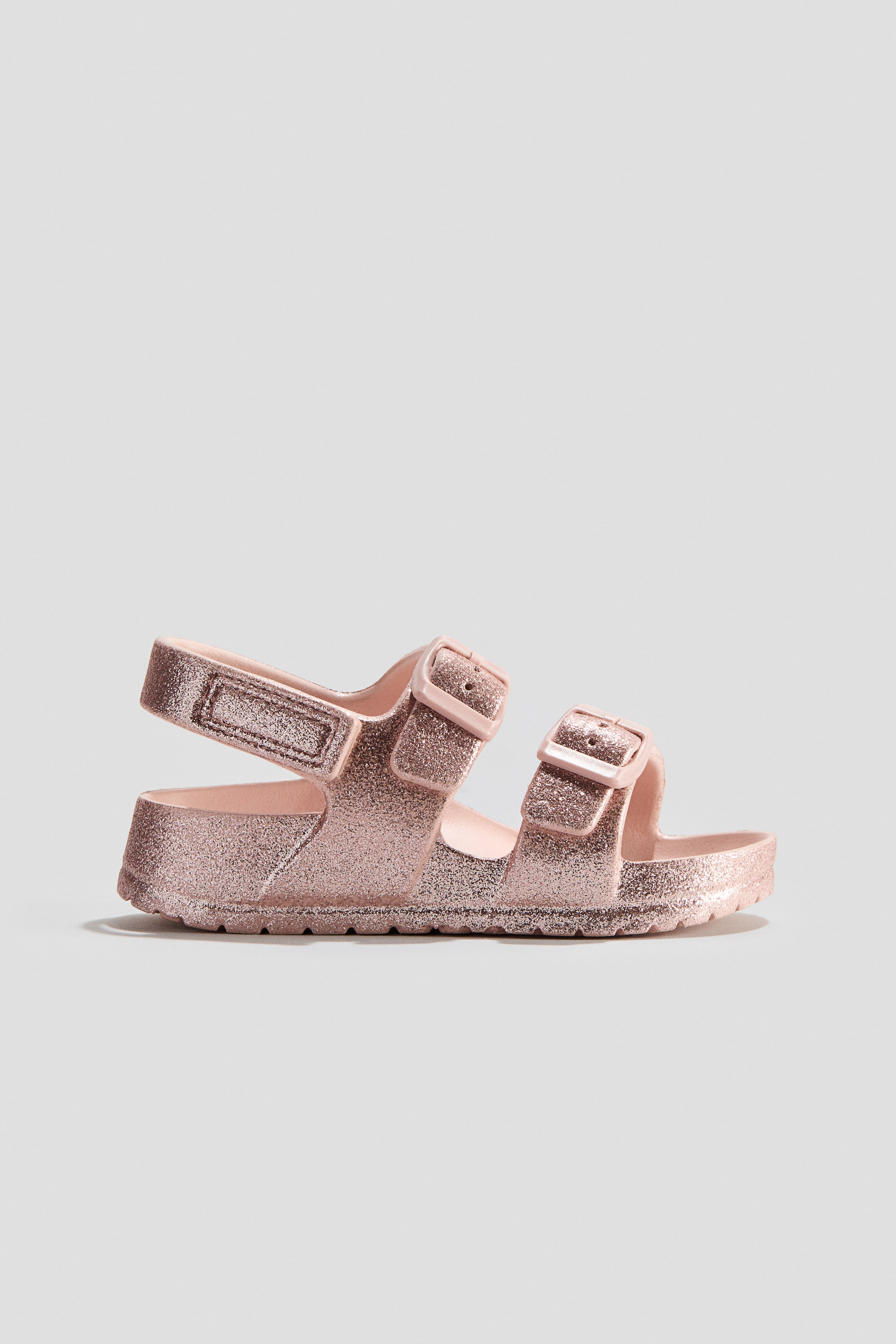 View larger image: Pink glitter pool shoes feature two adjustable foot straps with plastic buckles and an ankle strap with hook and loop fastening. Designed with moulded insoles and fluted soles.
