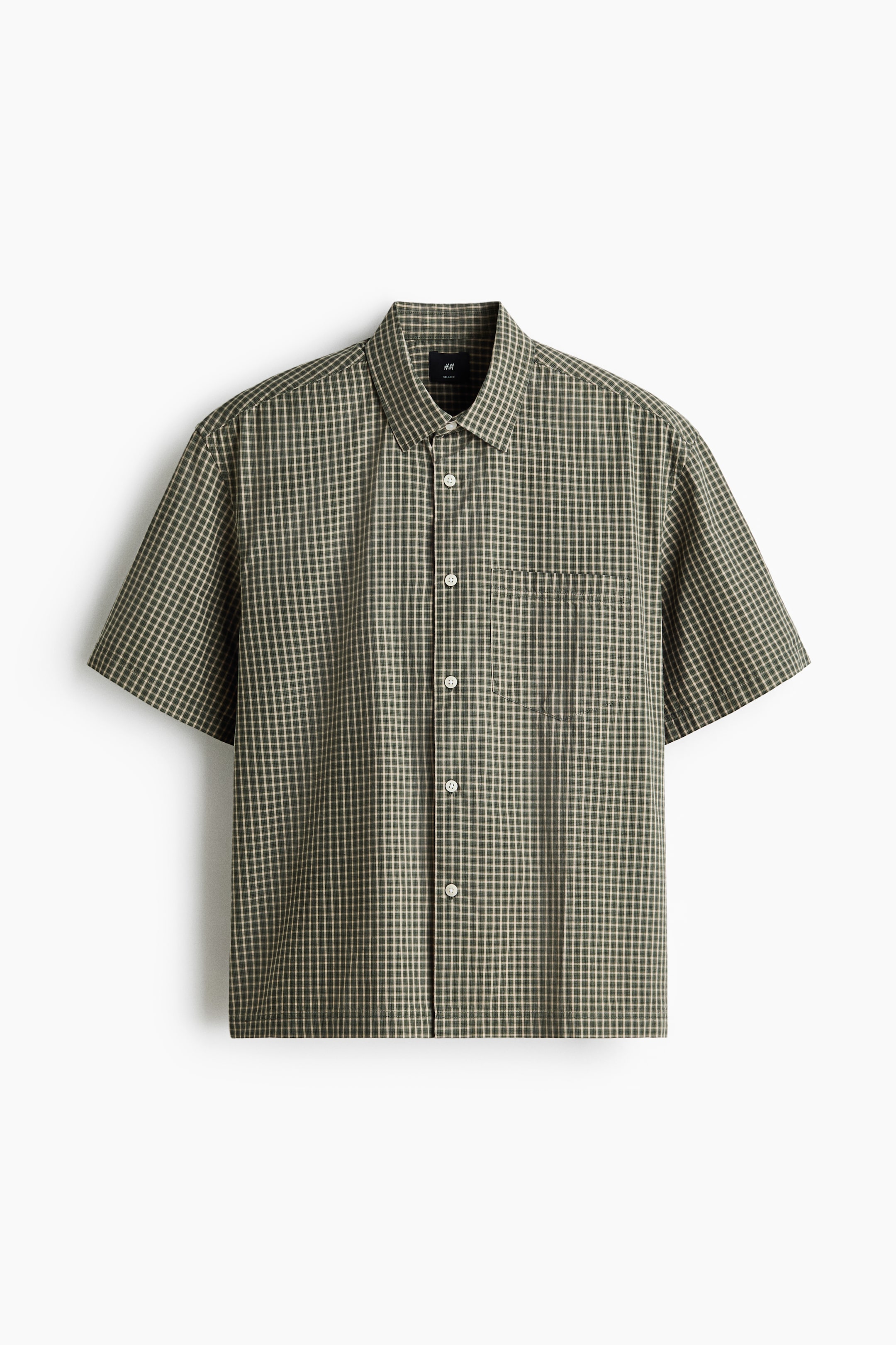 View larger image: The shirt is shown in a front view, showcasing a green and light beige check pattern. It features a pointed collar, short sleeves, a full button-down front with light-coloured buttons, and a single patch pocket on the left chest.