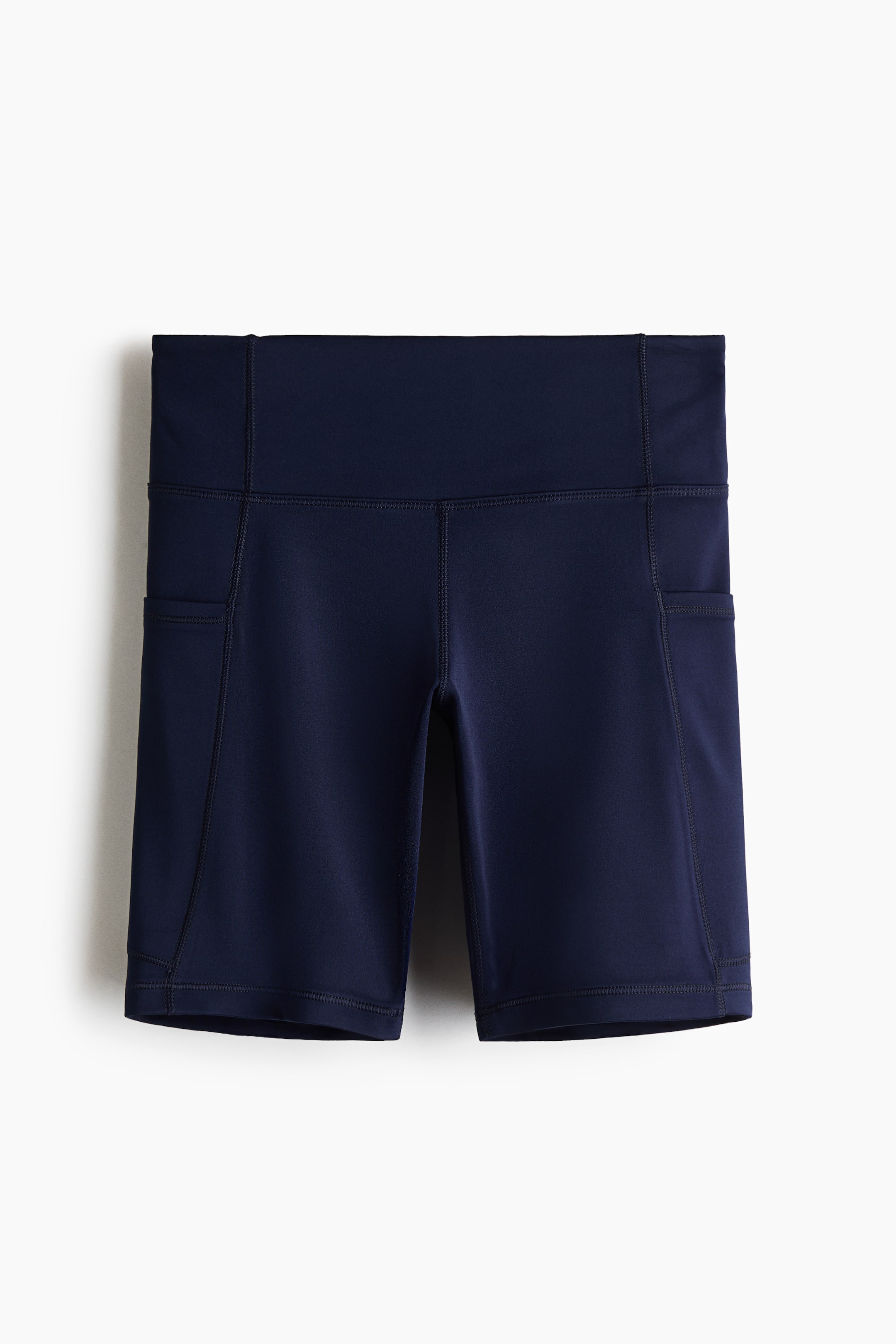 View larger image: Sports cycling shorts with DryMove? are shown in a front view, featuring a solid navy blue color and a wide, high-rise waistband. Side slip pockets are integrated into both thighs, with visible structured seams outlining the design.