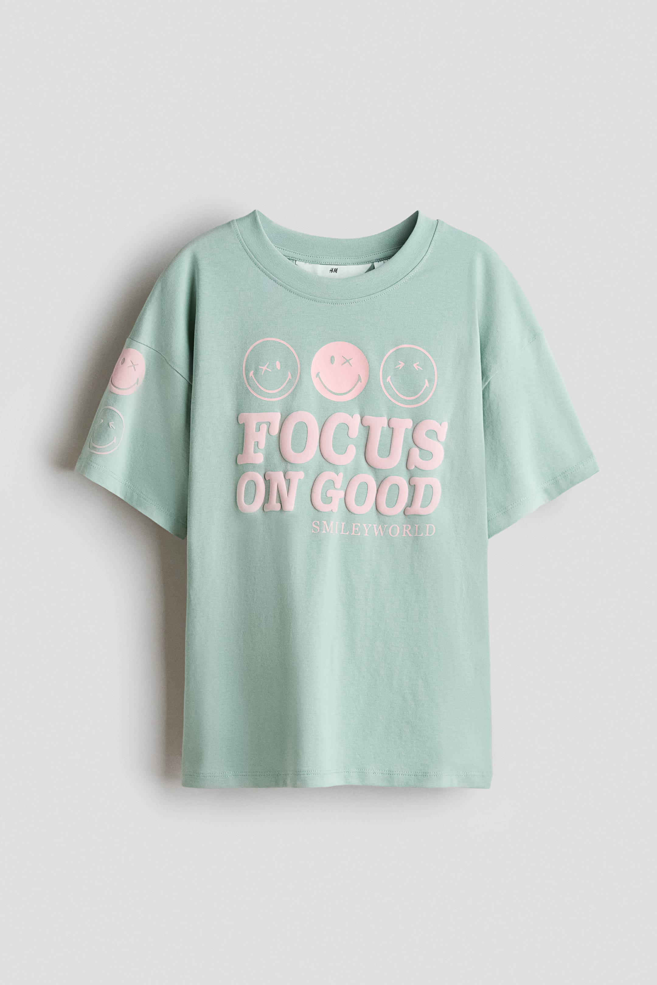 View larger image: Cotton T-Shirt with Printed Motif - Light green/SmileyWorld® - Kids | H&M US 1
