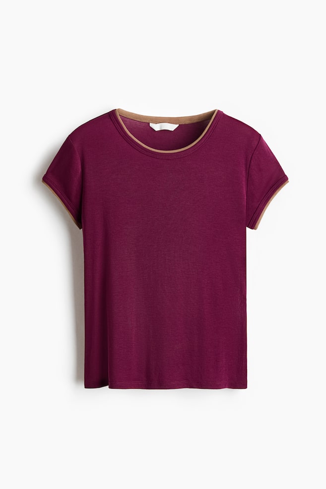 A burgundy short-sleeved ringer t-shirt is facing the front, displaying a contrasting tan trim along the crew neckline and sleeve cuffs. - 1