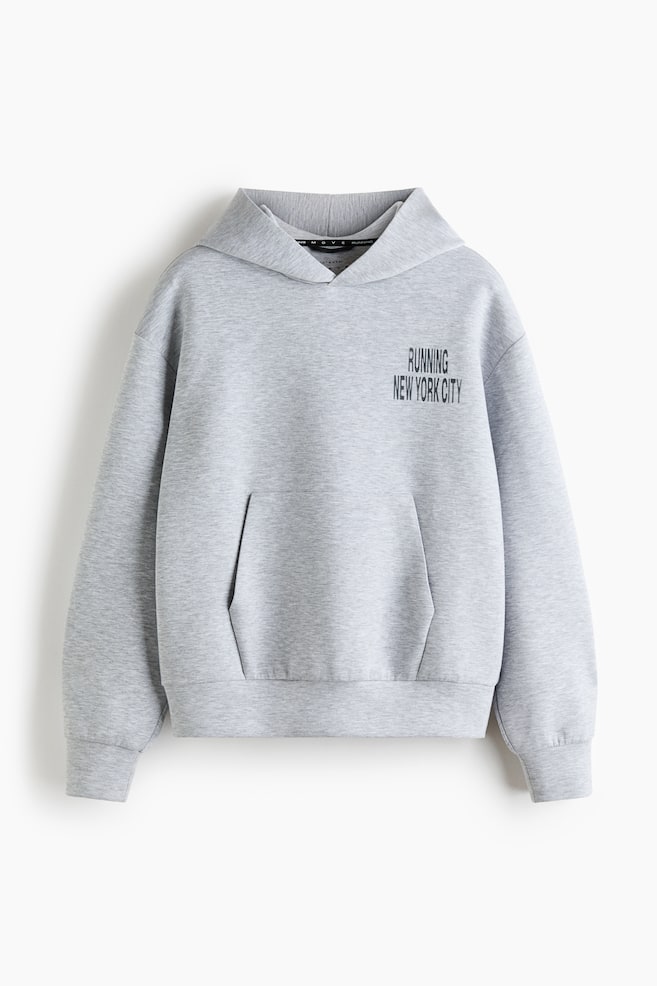A light grey heather hoodie is facing front, featuring a hood, long sleeves with ribbed cuffs, and a ribbed hem. It is displaying a front kangaroo pocket and black text that reads "RUNNING NEW YORK CITY" on the left chest. - 1
