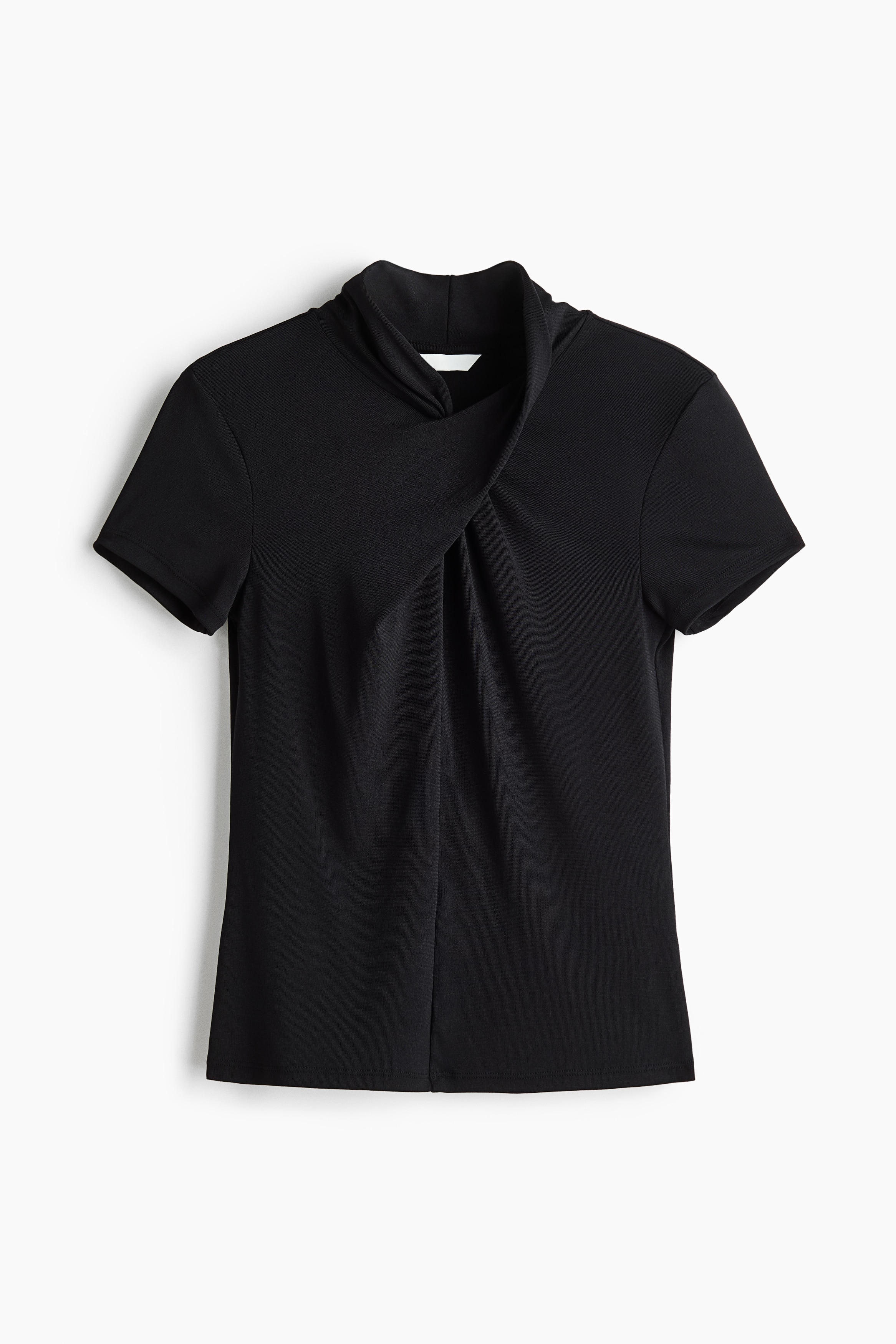 A black, short-sleeved fitted top featuring a stand collar with a twisted, draped detail at the front is being worn by the model. The top is styled with wide-leg black leather trousers.