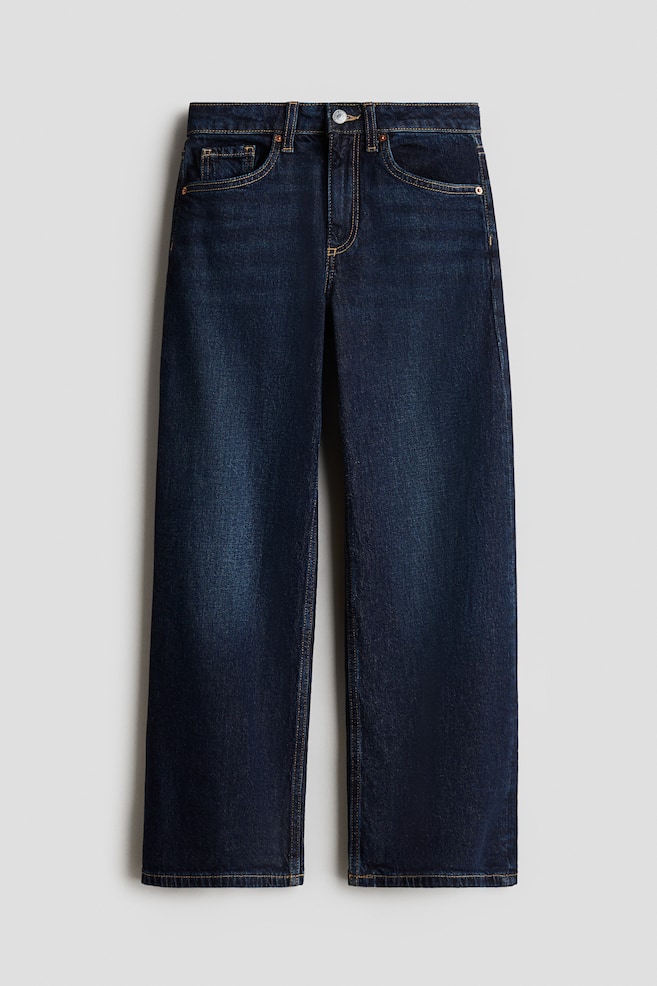 FRONT view of dark blue, washed cotton denim jeans, featuring a high waist, a zip fly with a button, wide legs, and a 5-pocket design with contrasting stitching. - 1