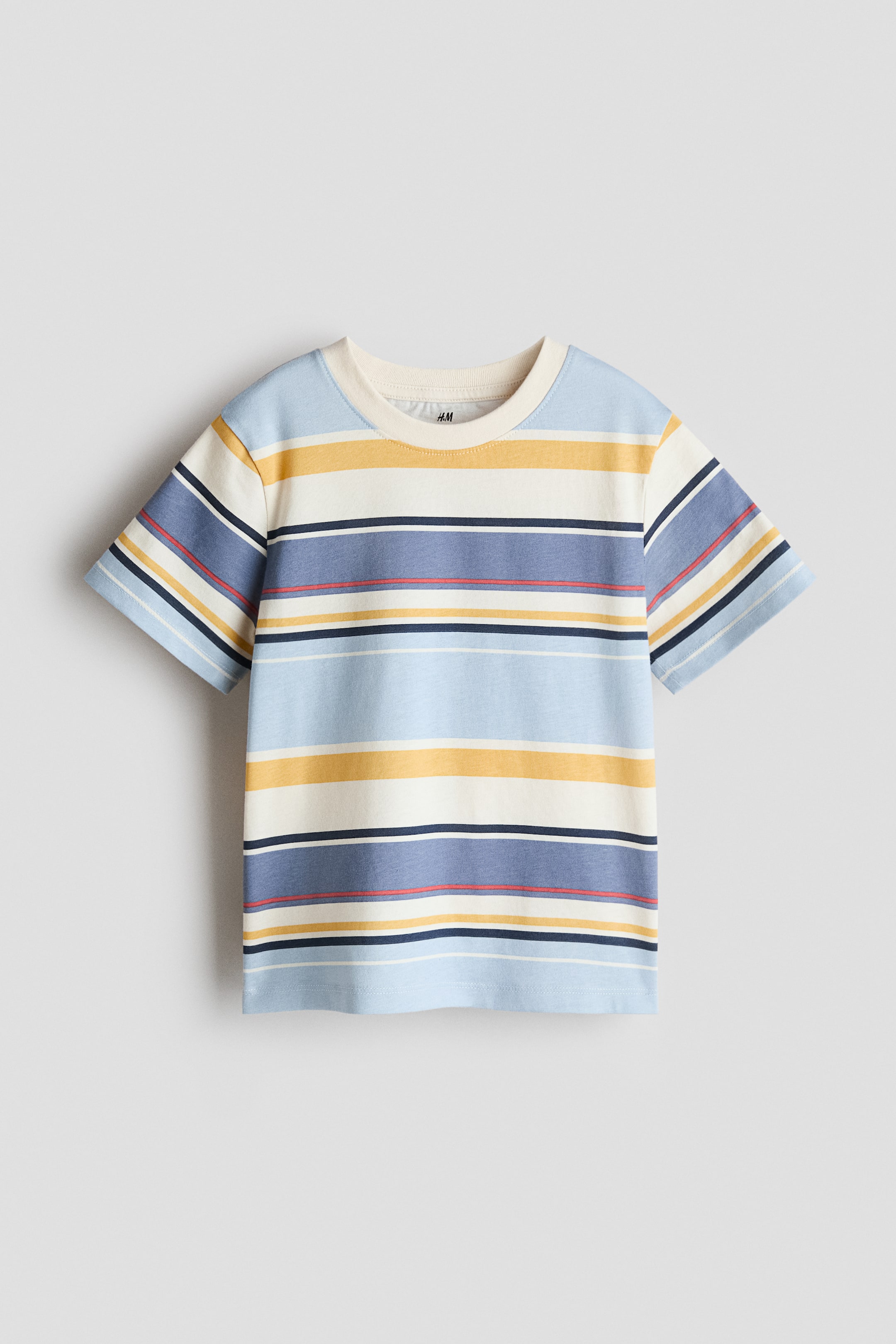 View larger image: This T-shirt showcases its front, crafted from a printed cotton jersey fabric adorned with horizontal stripes in light blue, yellow, cream, dark blue, and fine red and white lines. It is styled with a cream ribbed trim around the neckline and features dropped shoulders.
